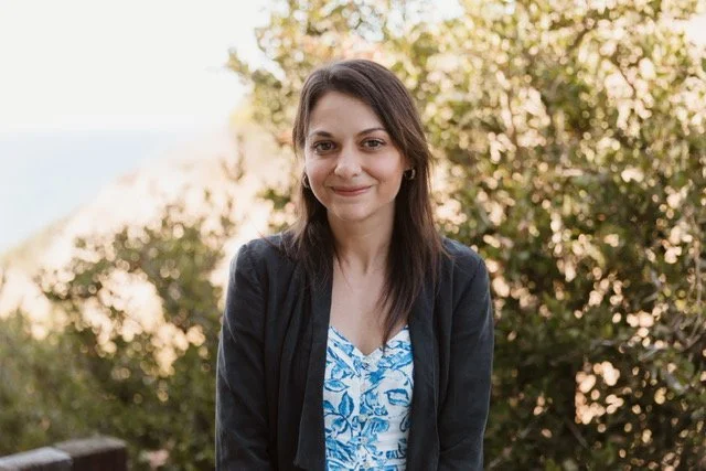 Morgan Abraham, LMFT with dark hair smiling outdoors