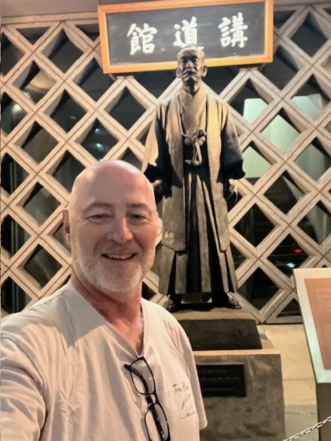 Boyd with Jigoro Kano's statue outside The Kodokan
