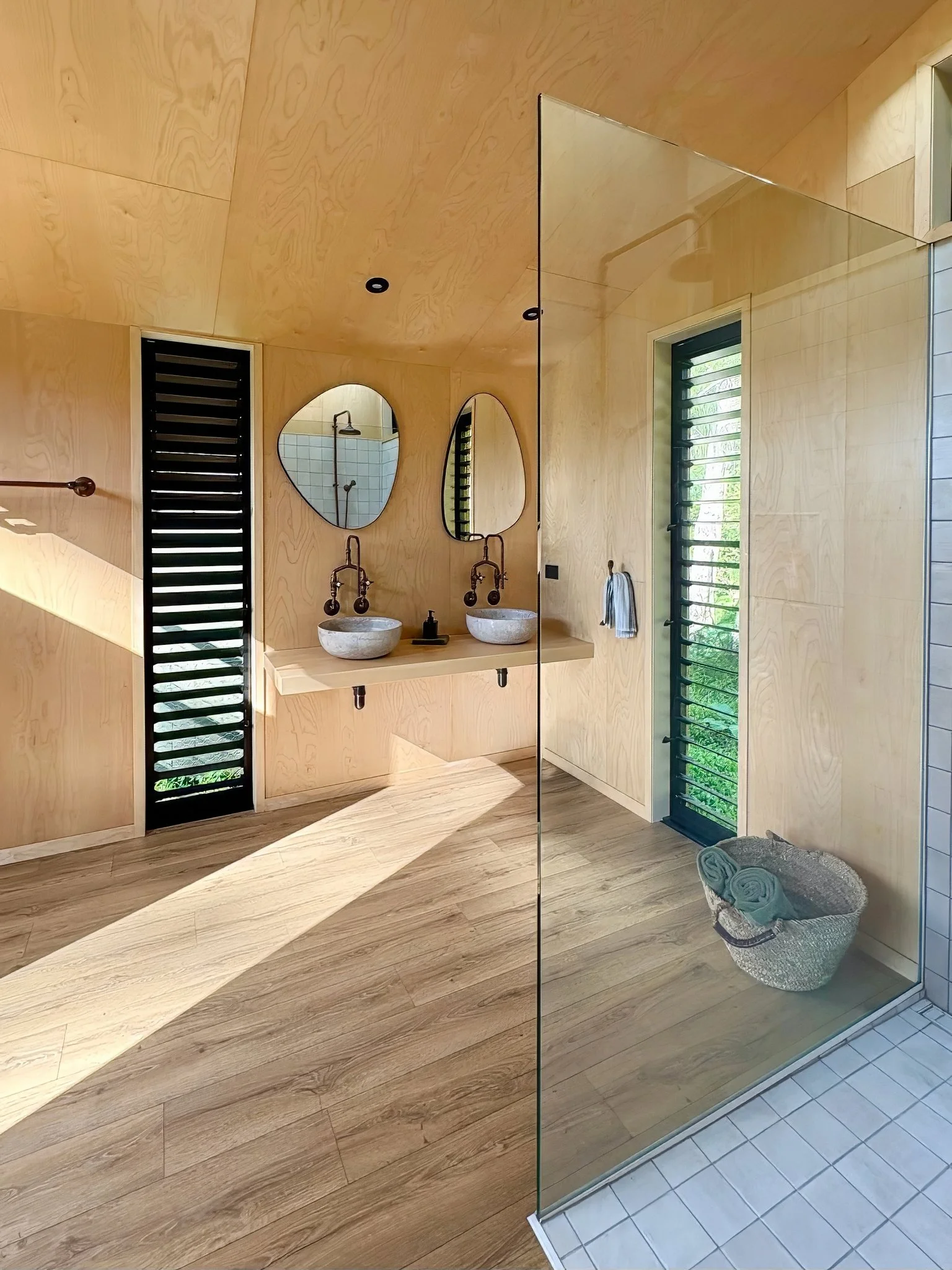 Custom American ash vanity with stone bowls, Black Swamp glamping bathroom