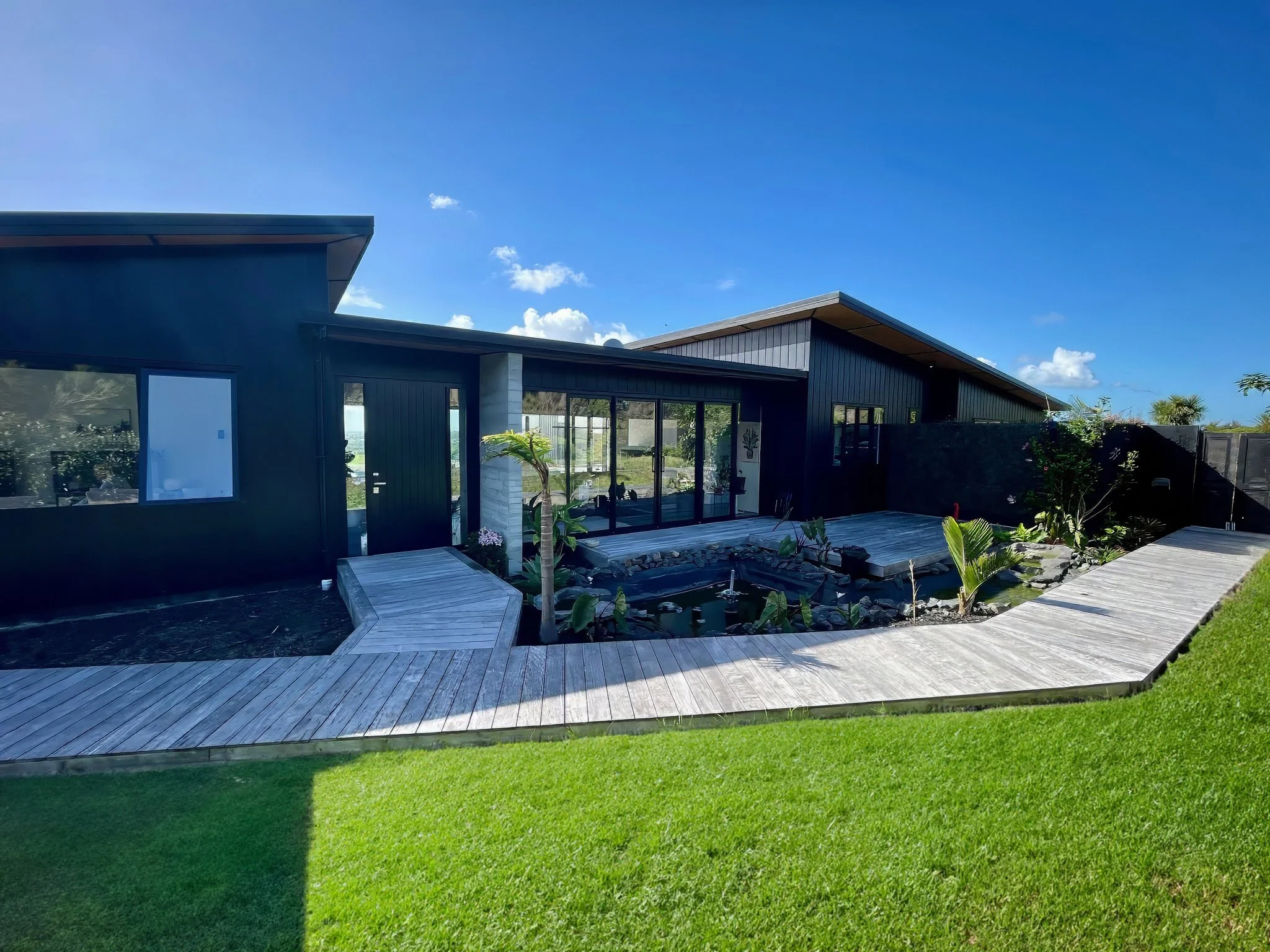 Sanctuary Ridgeview new home dark exterior cladding and landscaped gardens, Mangawhai