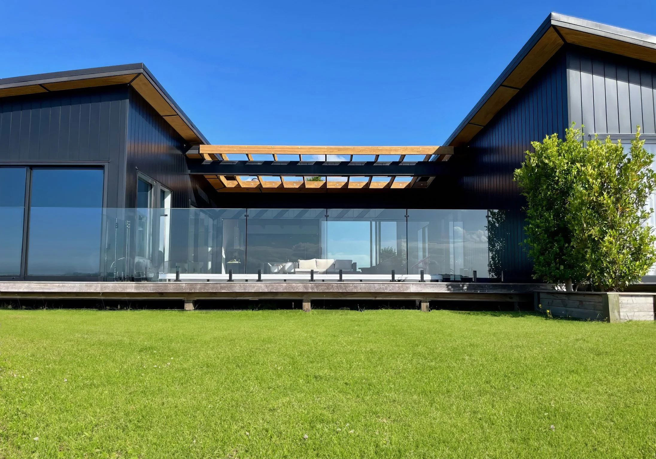 Sanctuary Ridgeview luxury new home exterior with manicured lawn, Mangawhai