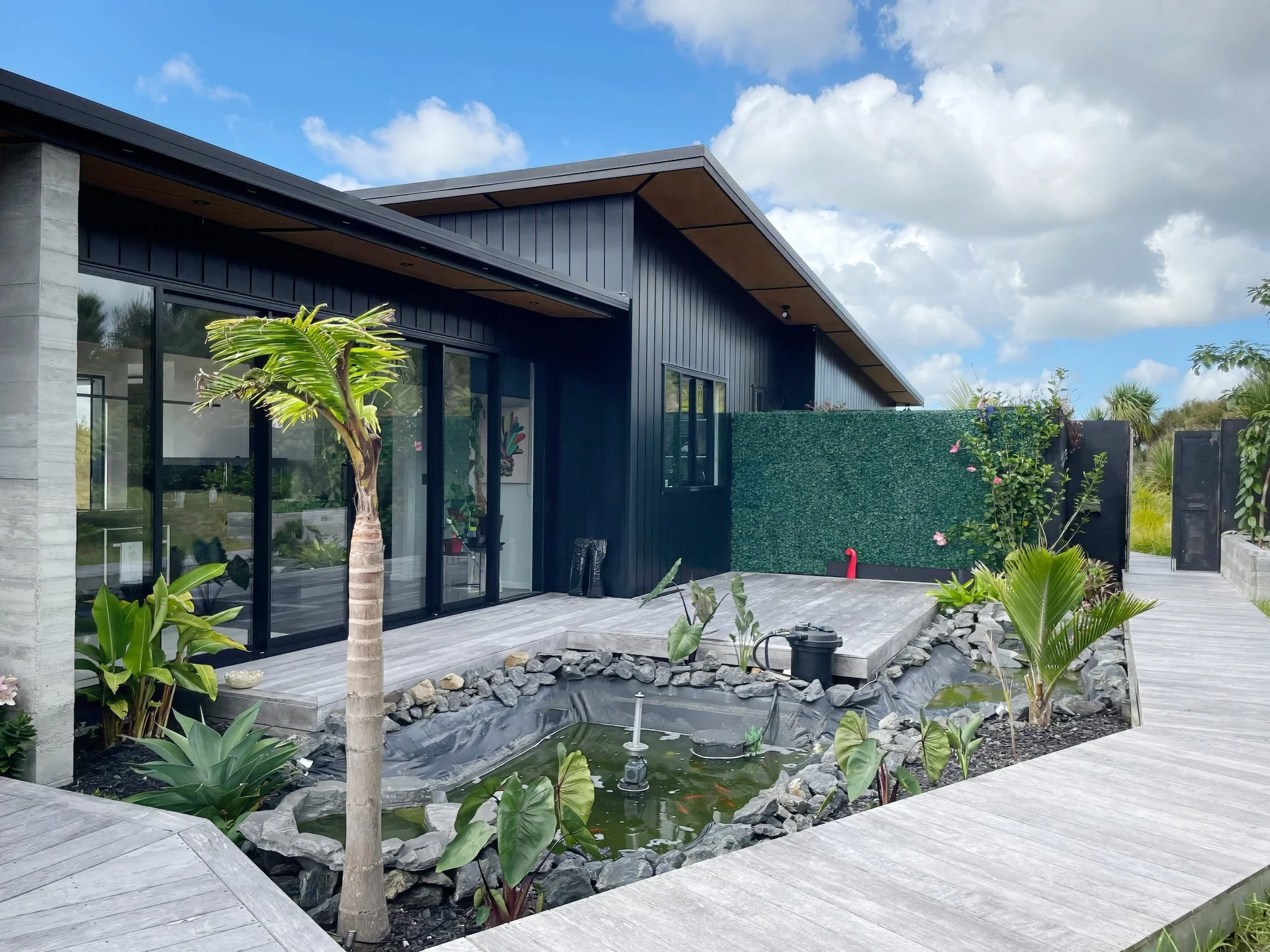 Sanctuary Ridgeview new home outdoor area with timber decking and fishpond, Elite Building Northland 