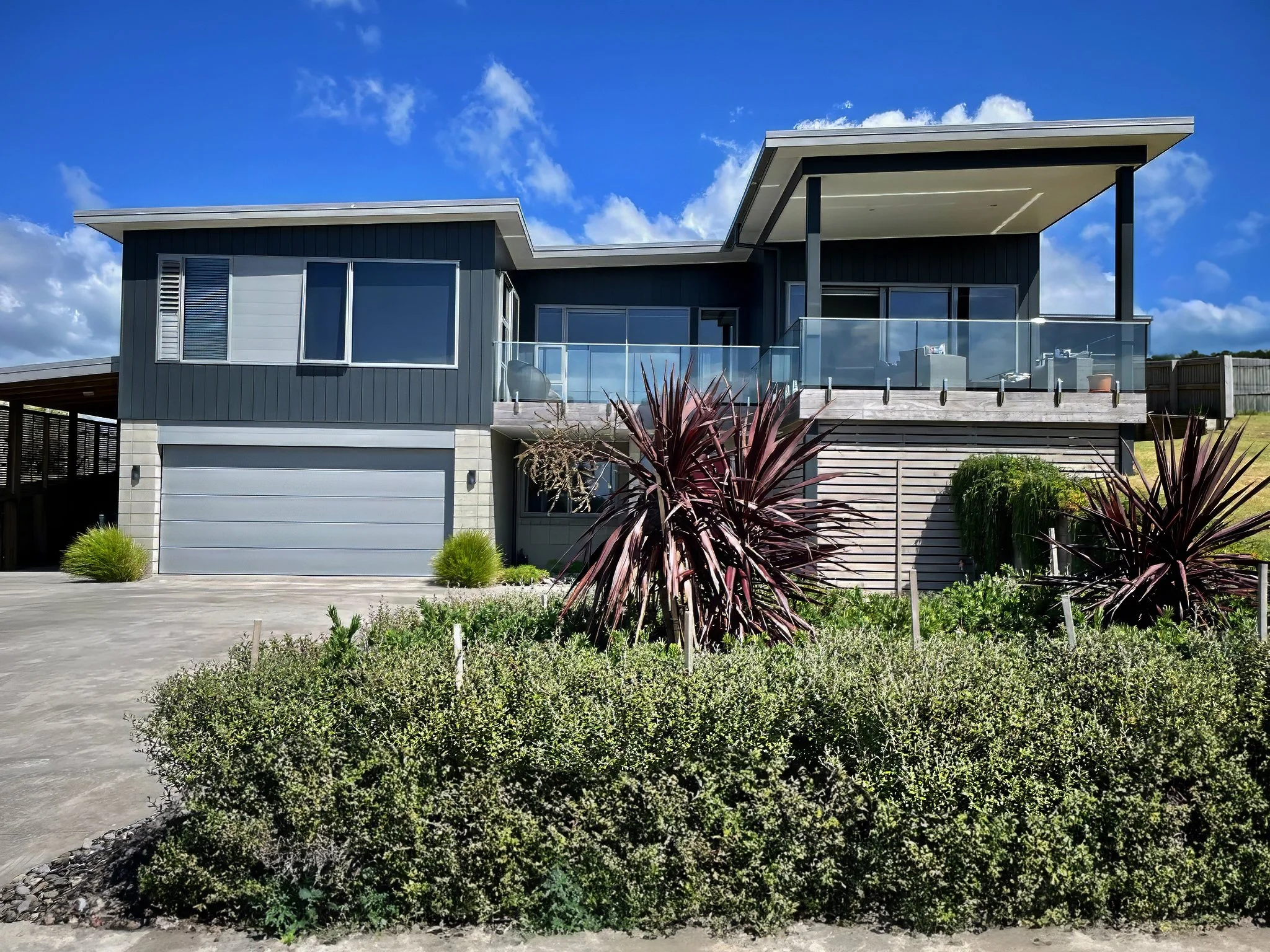 Driftwood two level new family home exterior with dark cladding, Elite Building Mangawhai