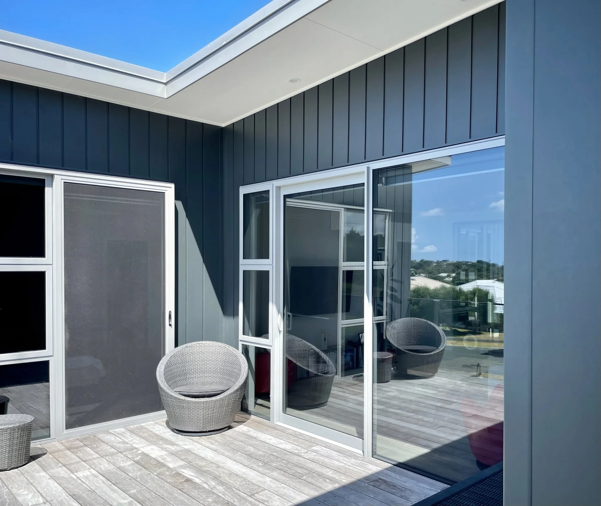Driftwood new home exterior decking with dark cladding, Elite Building Mangawhai