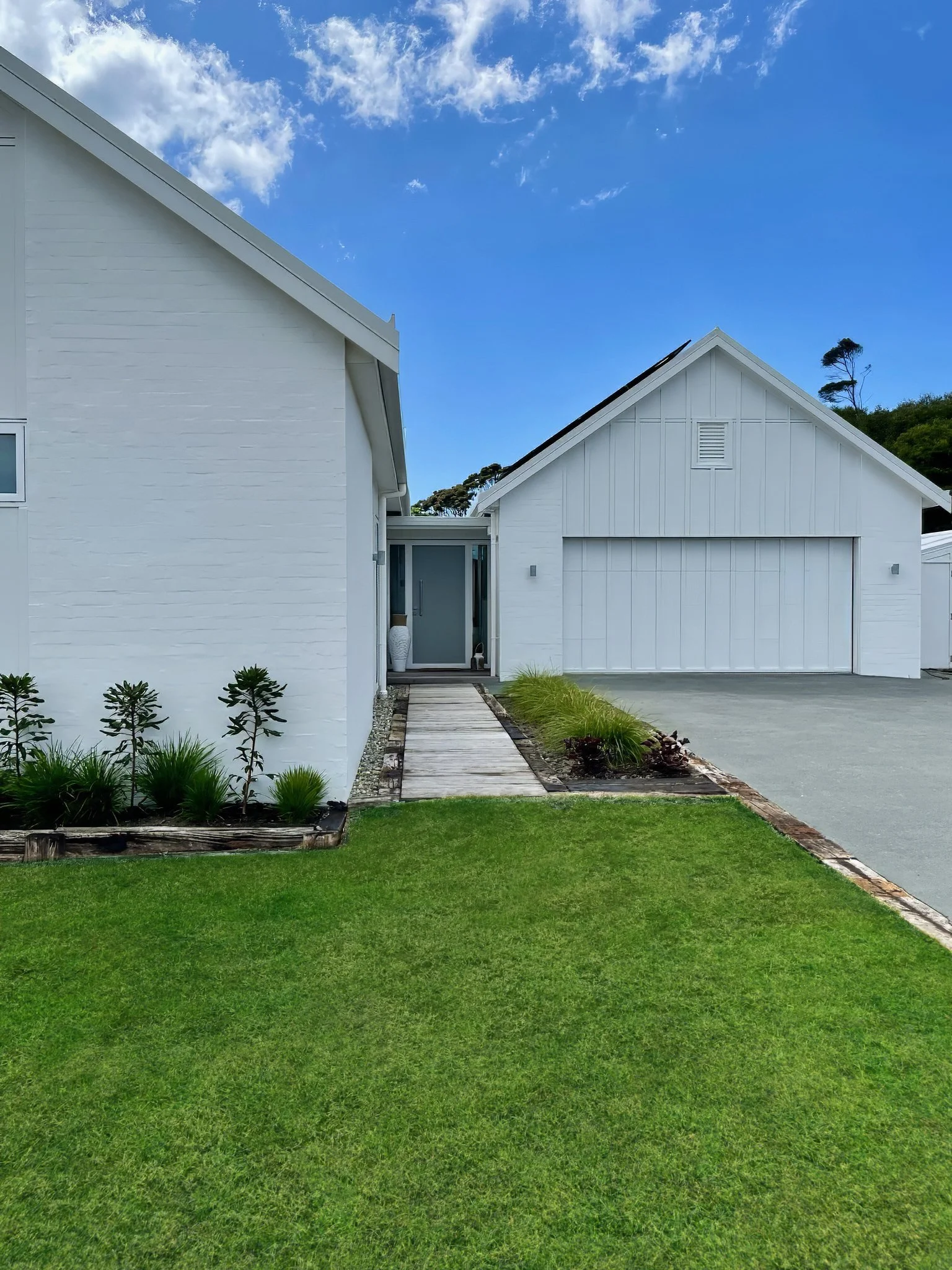 Swordfish luxury new home exterior with tropical planting, Mangawhai
