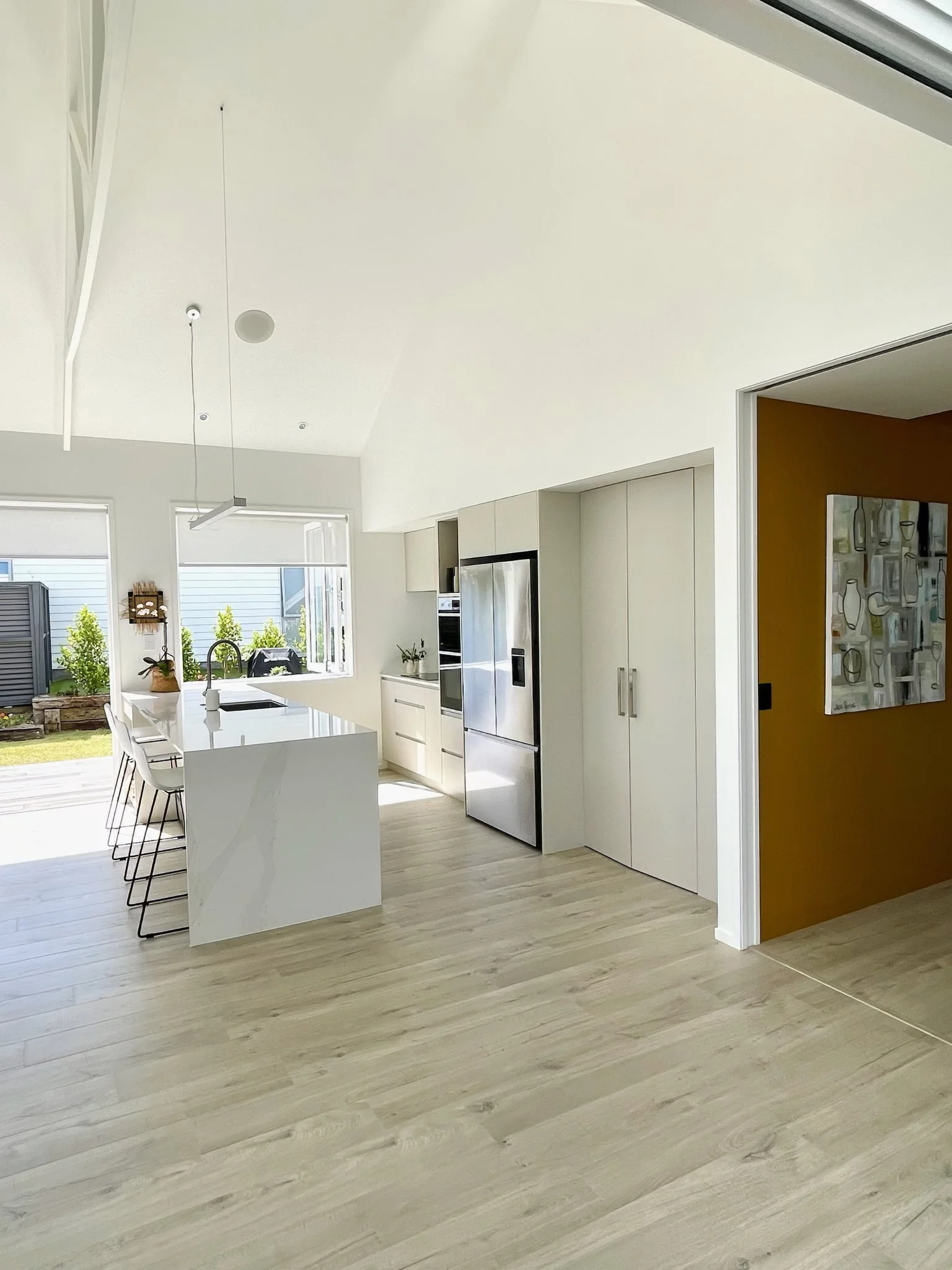 Swordfish luxury open plan living with light timber tones, Mangawhai