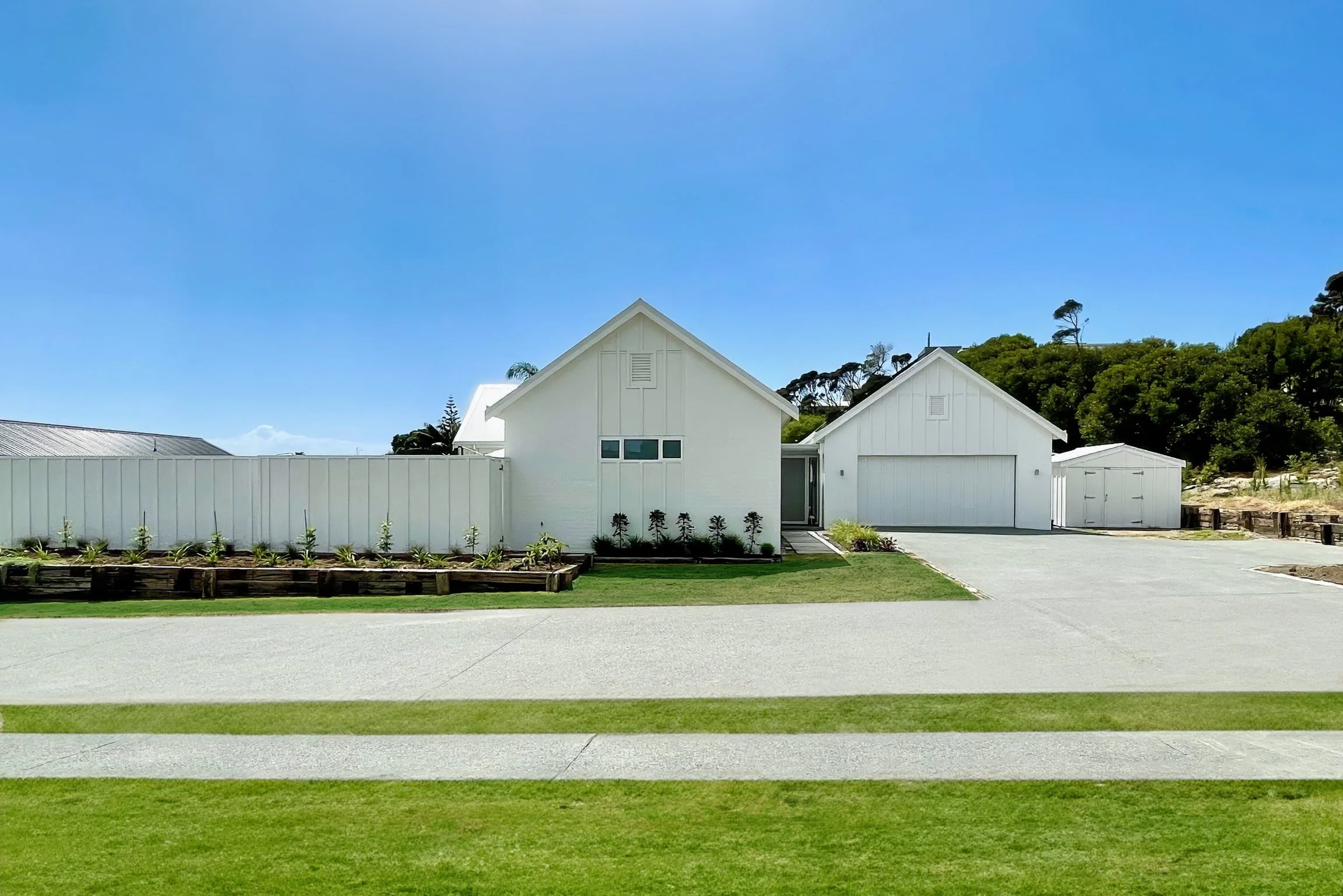 Swordfish new home  with white exterior and landscaped gardens, Mangawhai