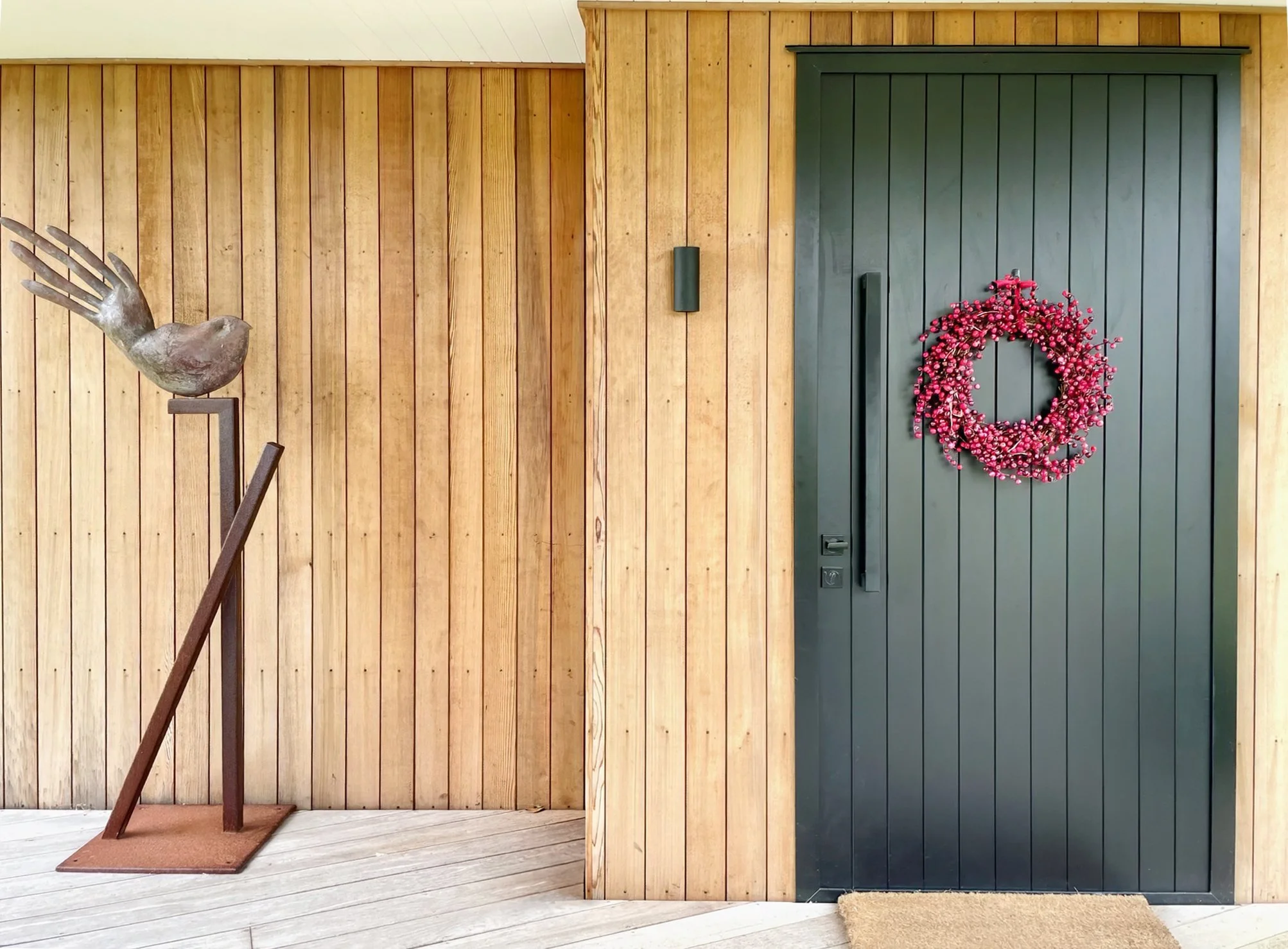 Timber clad entrance with dark front door, Waiotahi Drive new home build Elite Building Mangawhai