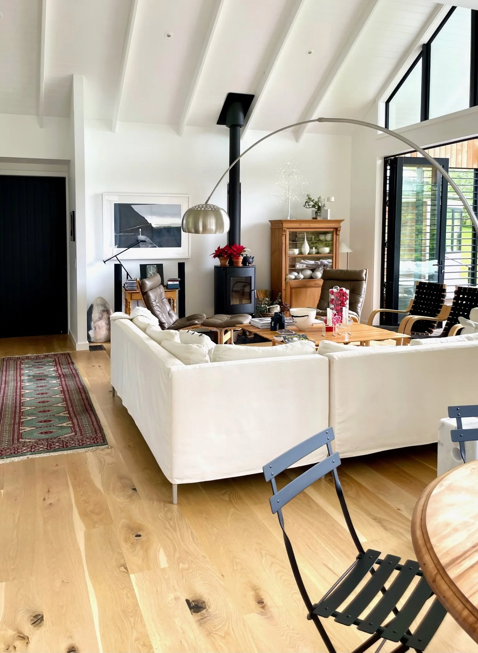 Open plan living room with log burner and timber flooring, Waiotahi Drive luxury home Elite Building Mangawhai