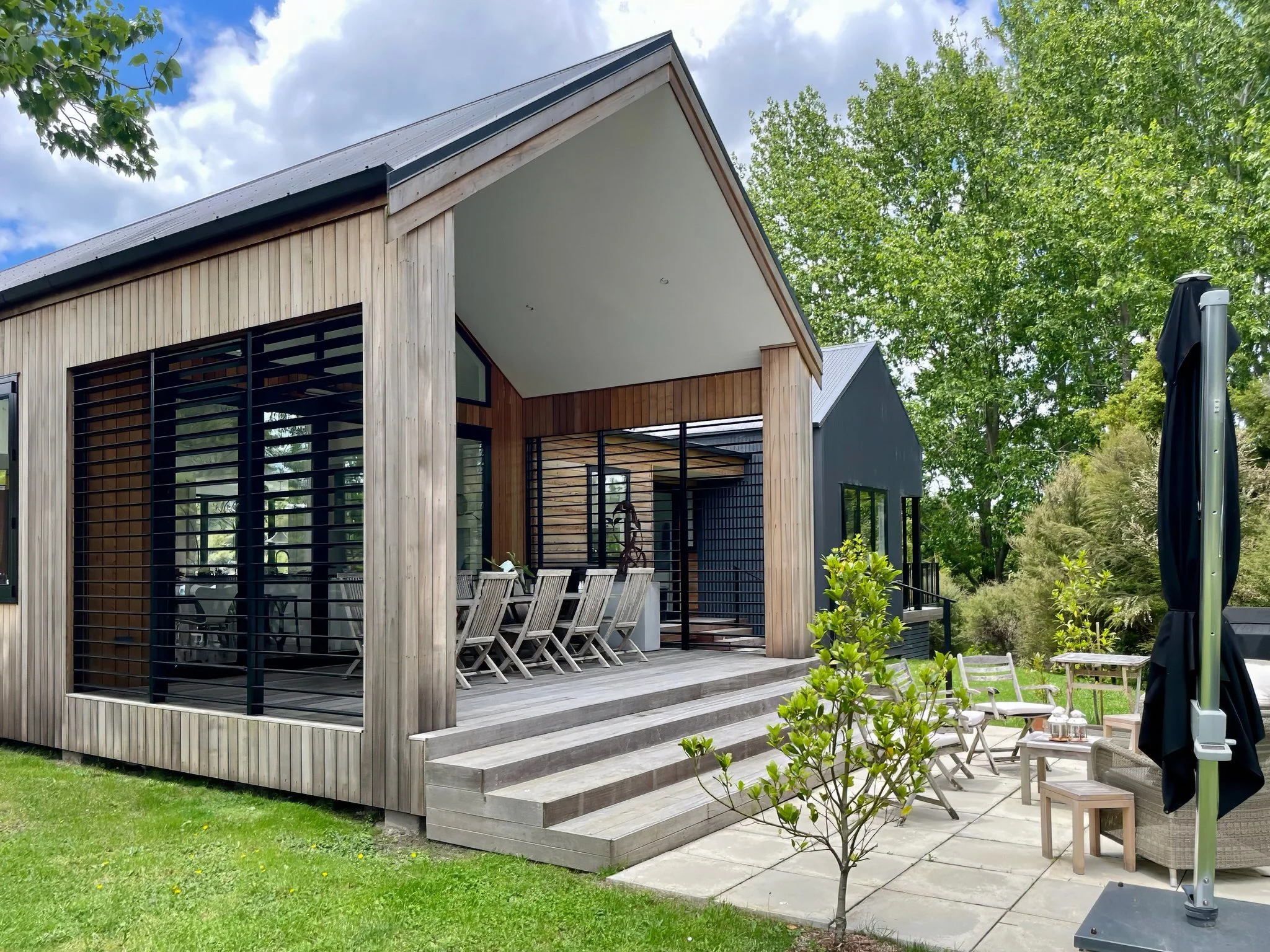 Waiotahi Drive luxury home exterior with louvre shutters and established gardens, Elite Building Mangawhai