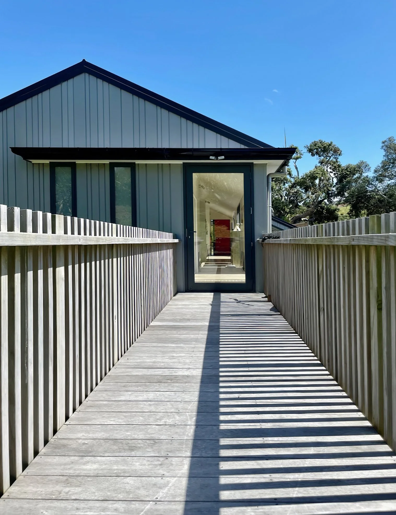 Mangawhai Point new home back entrance with outdoor deck and estuary views, Mangawhai