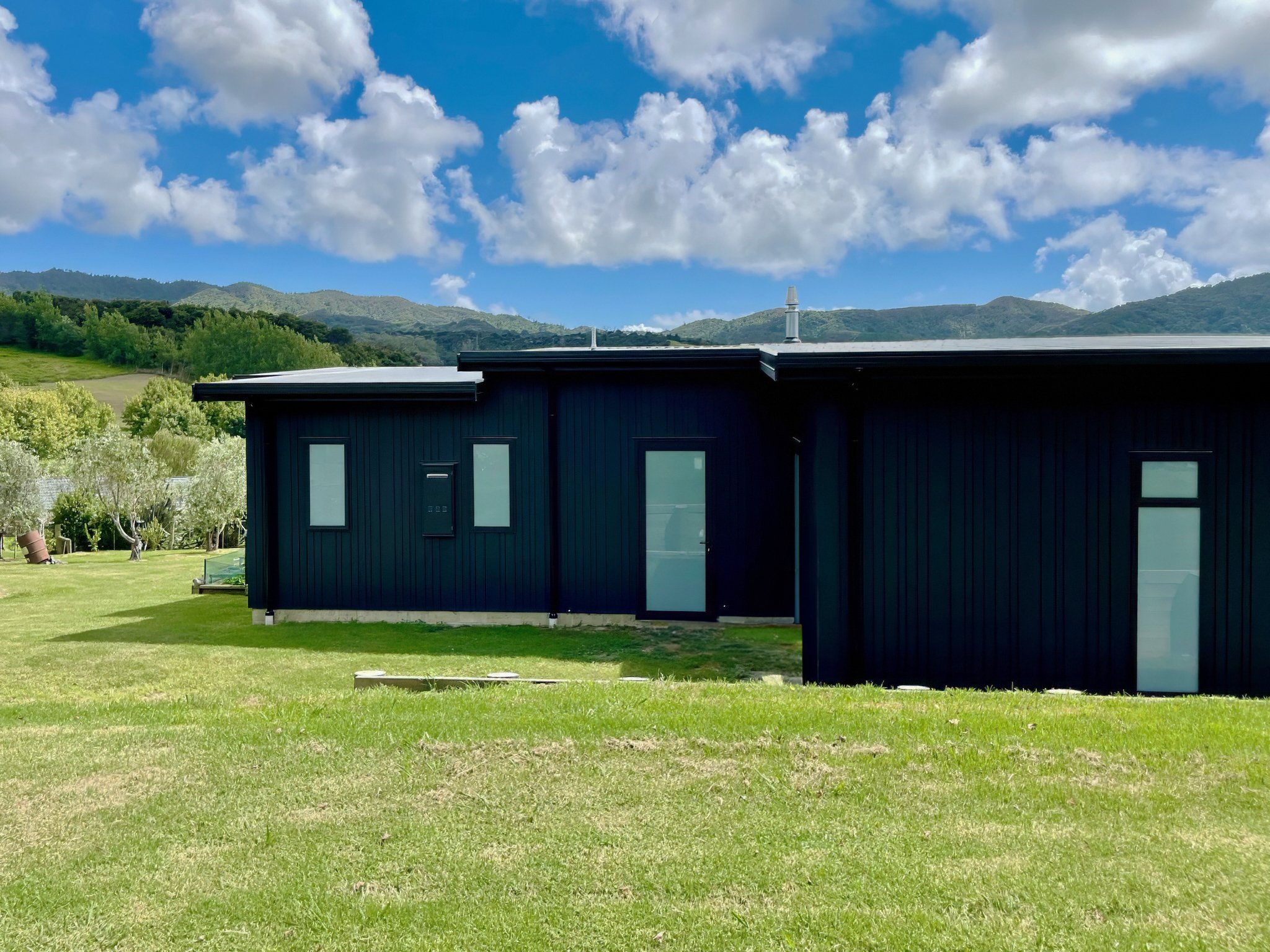 King Road luxury new home back exterior with dark cladding, Mangawhai