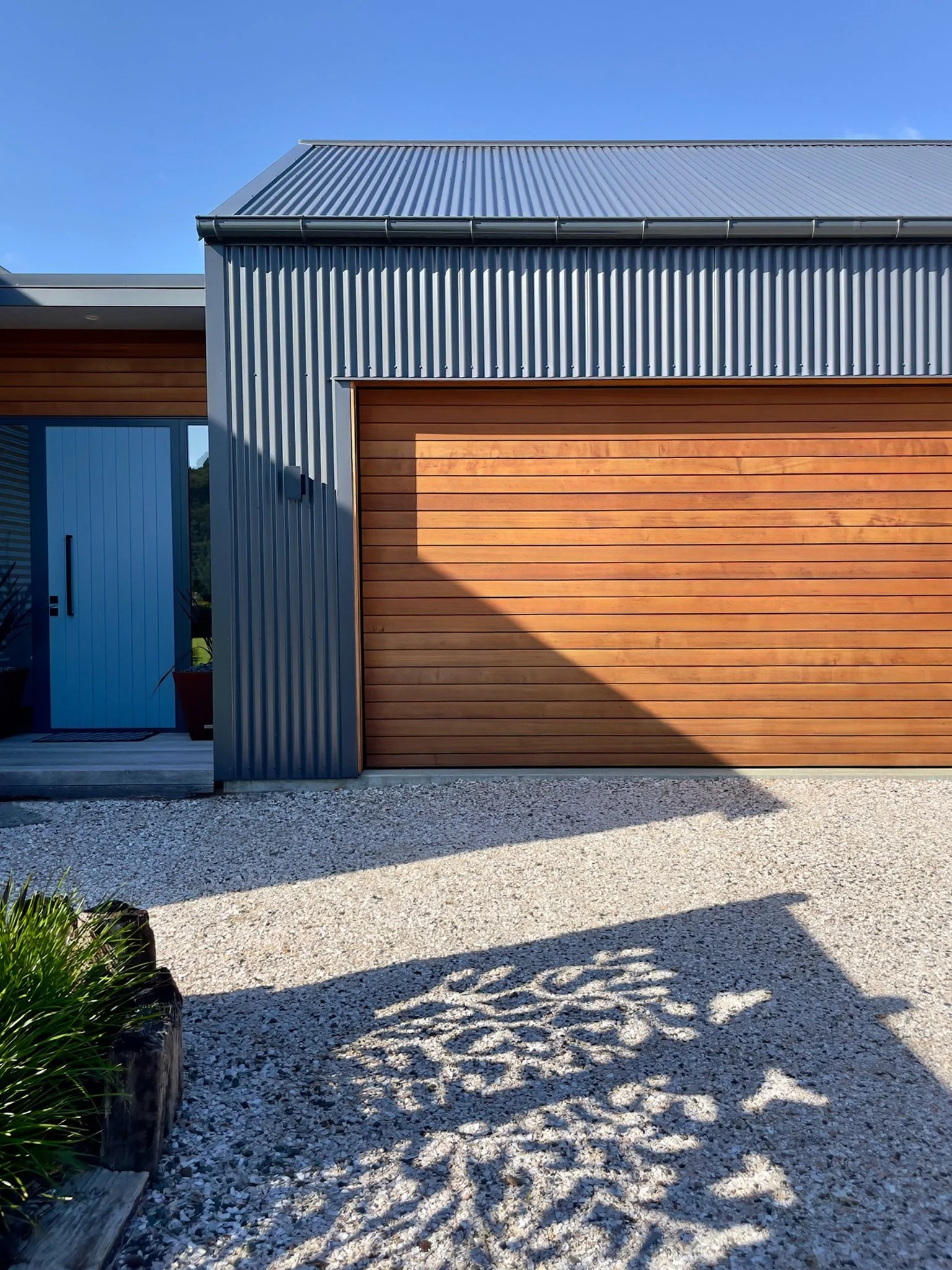 Alexandra Lane new home with cedar and colour steel exterior and timber garage door, Elite Building Northland