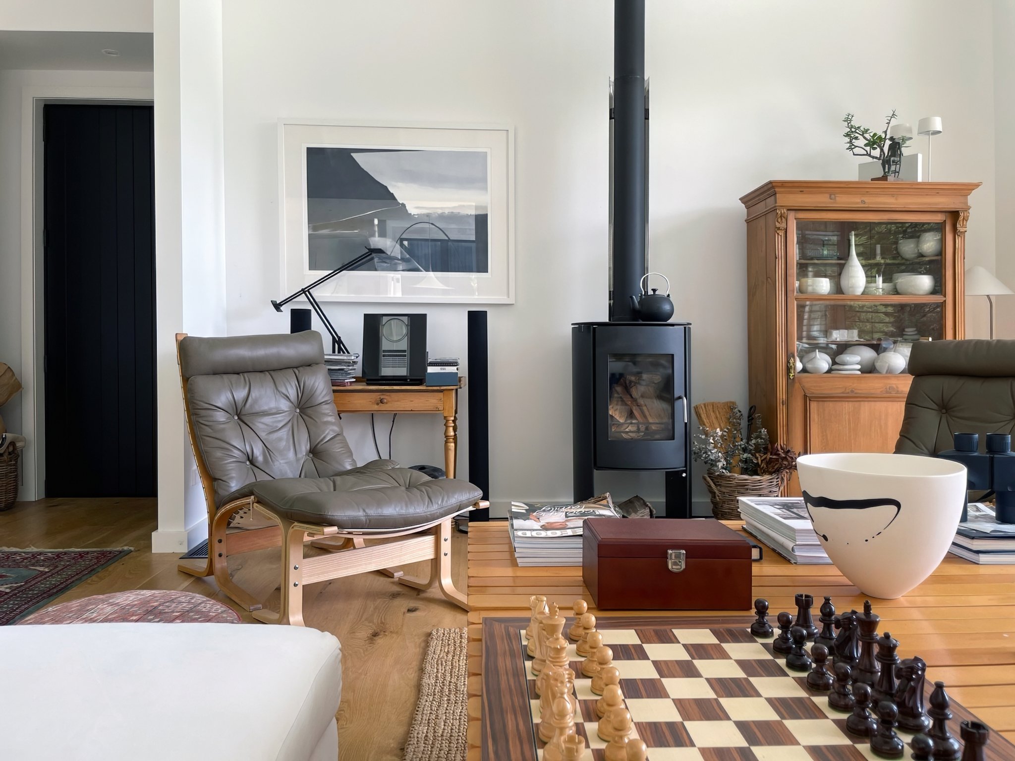 luxury home lounge room with wood burner fireplace and chess set