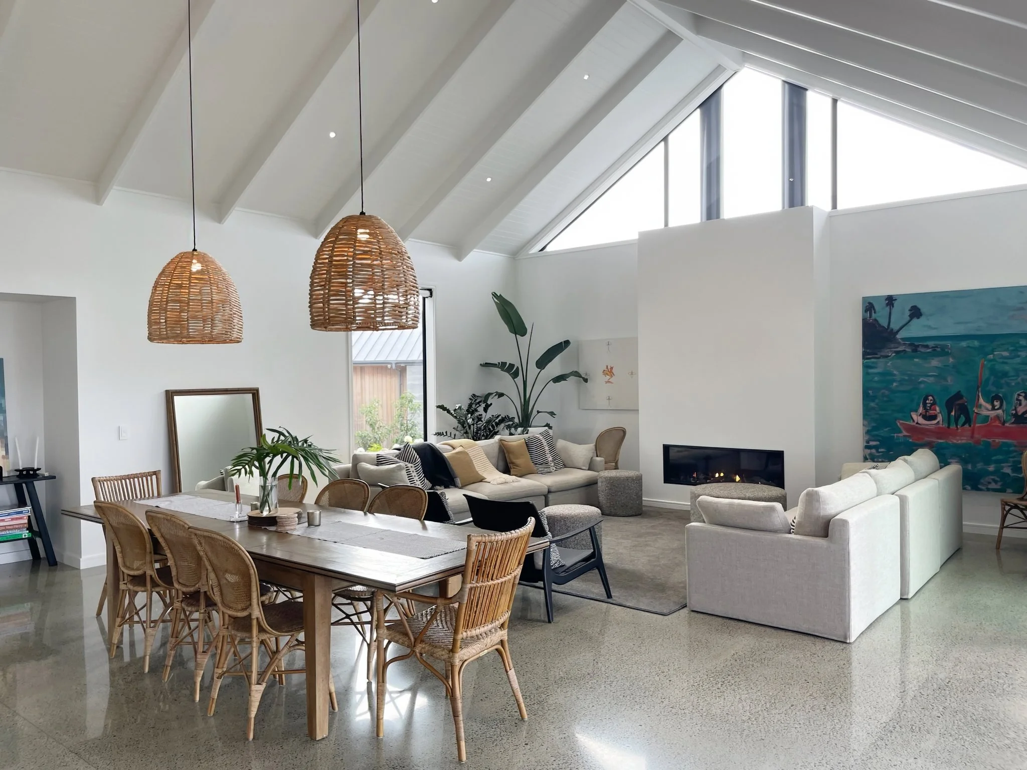 Sand Dune luxury living area with rattan pendant lighting and coastal styling, Mangawhai