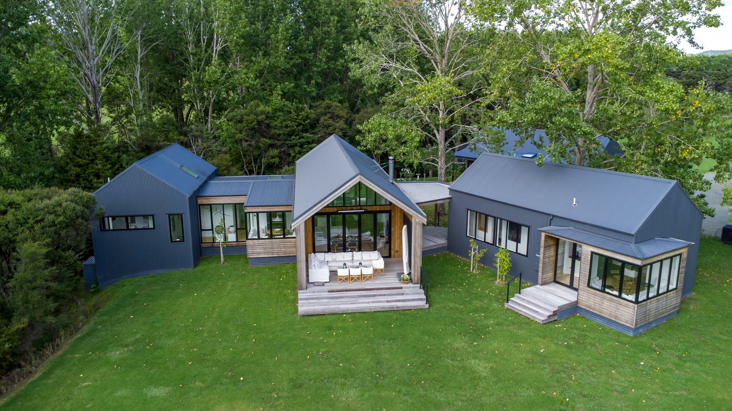 New home build with outdoor living area and manicured lawn, Elite Building Mangawhai  - arial drone shot