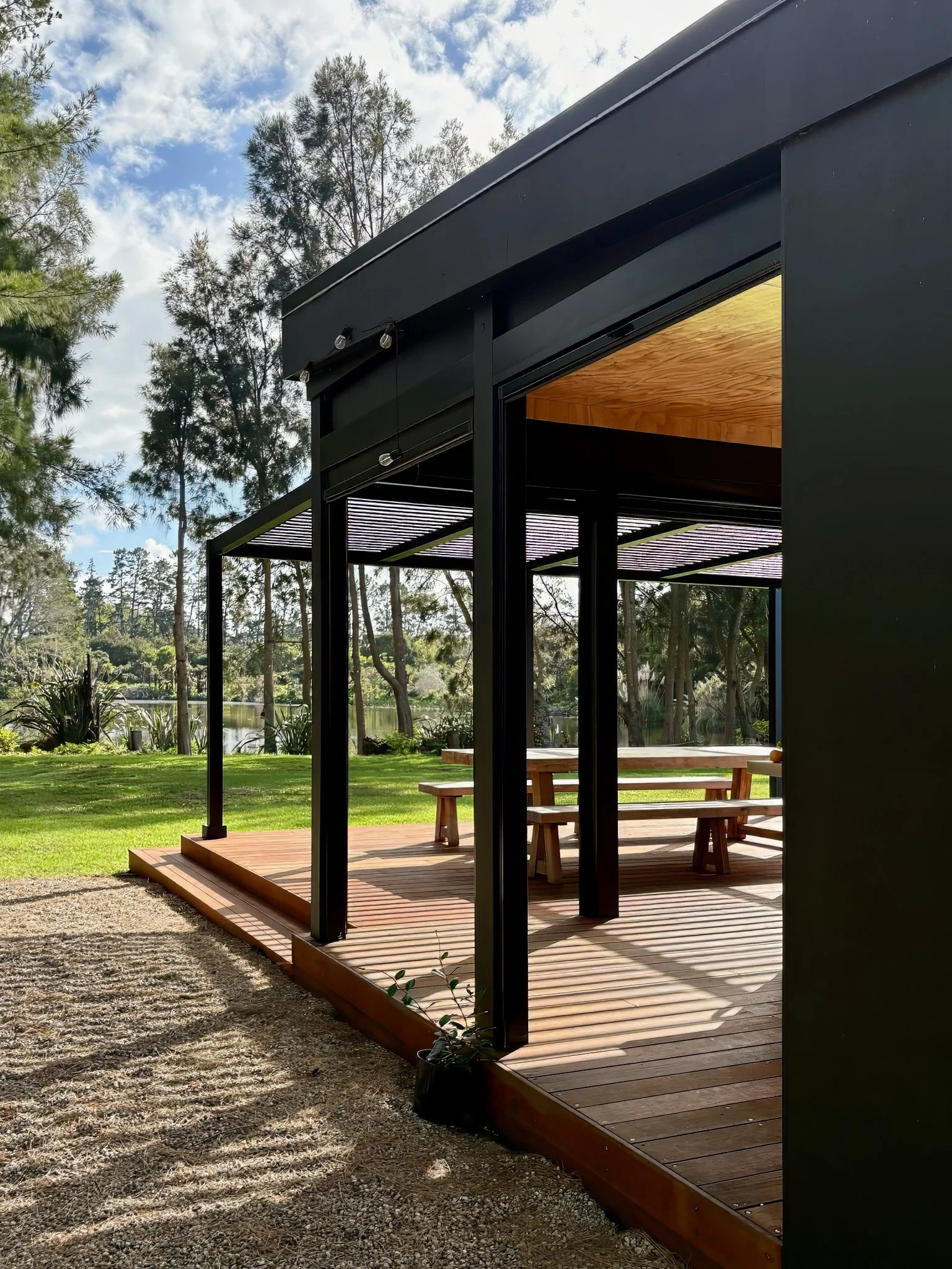 Outdoor kitchen pavilion with louvre dining area overlooking lake, Black Swamp Mangawhai