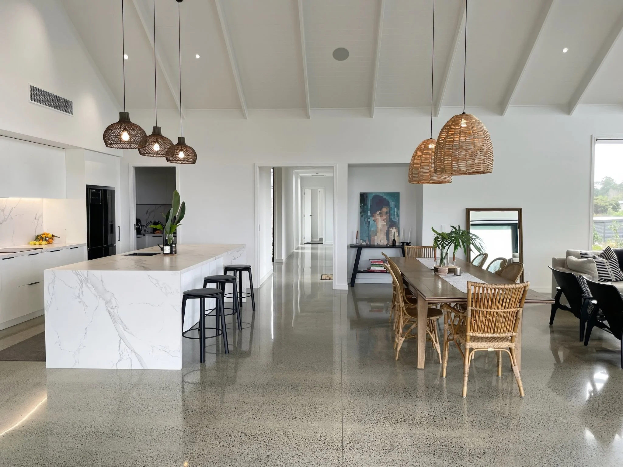 Open plan kitchen with pendant lighting and marble benchtop, Elite Building Mangawhai