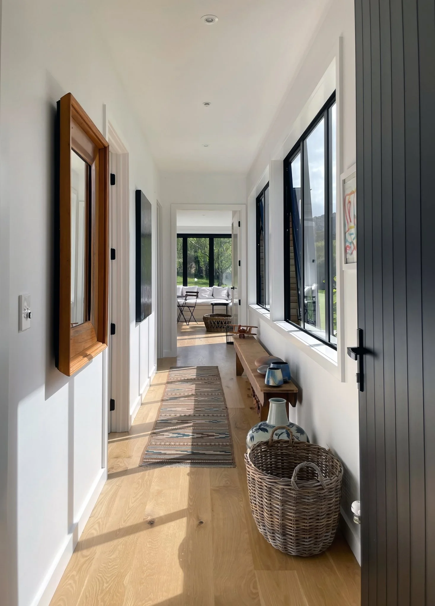Interior hallway with timber door and natural light, Waiotahi Drive new home Elite Building Northland