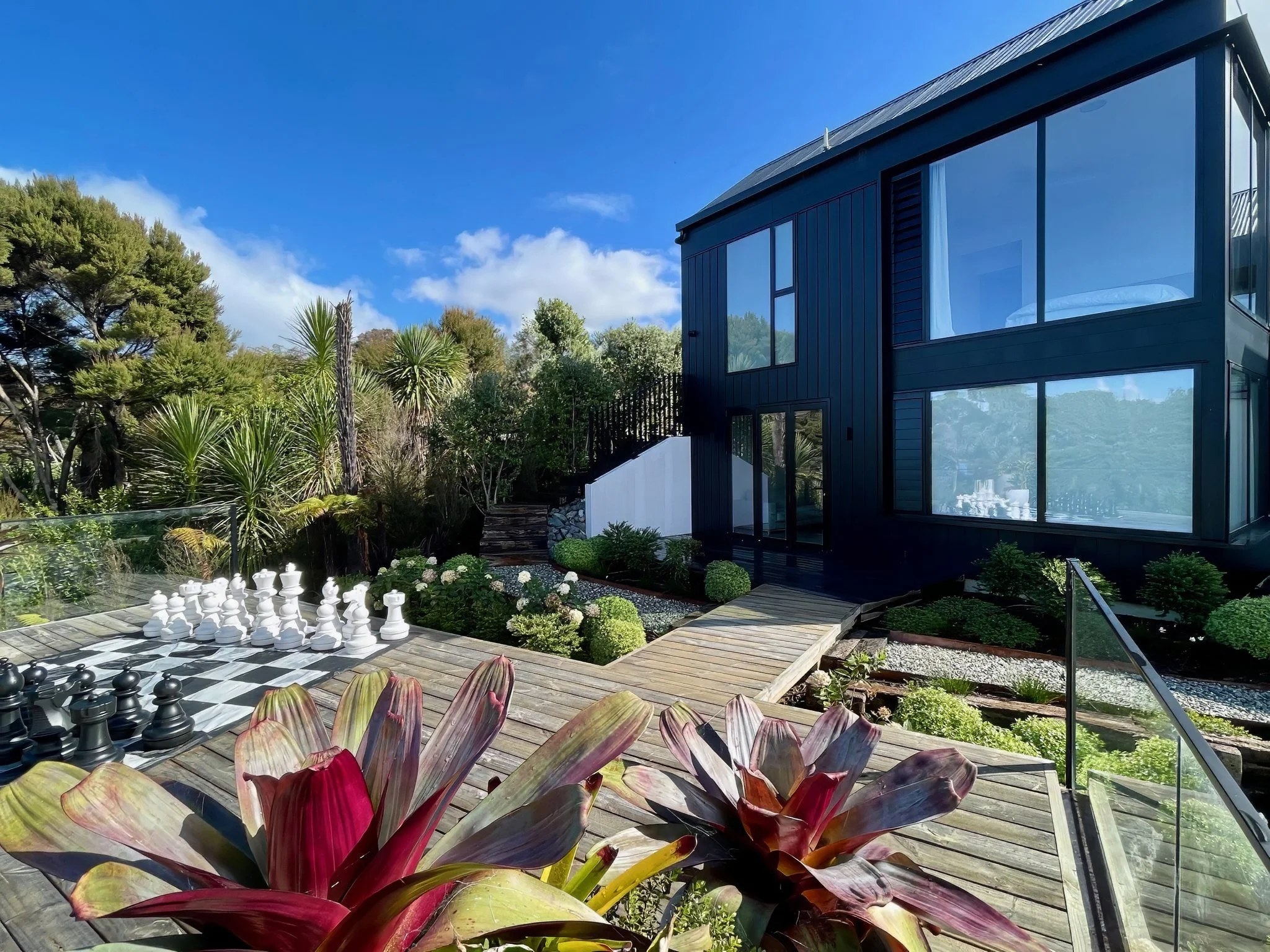 Sand Dune new home exterior with tropical garden planting, Mangawhai