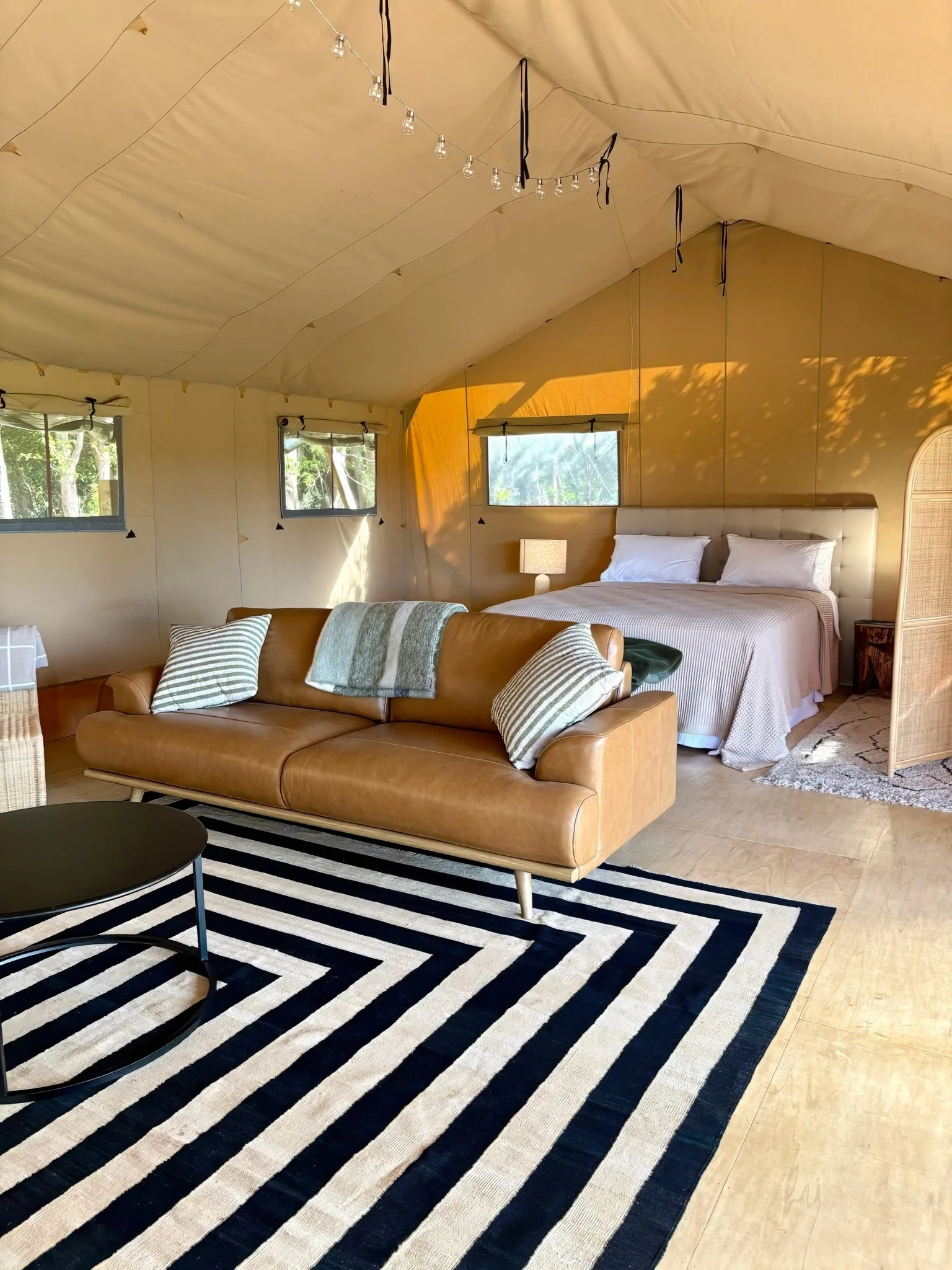 Luxury safari tent bedroom interior with king bed, Black Swamp glamping retreat Mangawhai