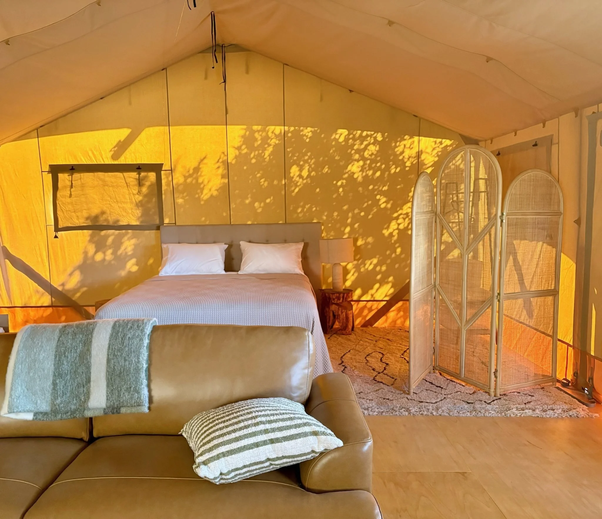 Cosy glamping tent bedroom at night, Black Swamp luxury retreat Te Arai Northland