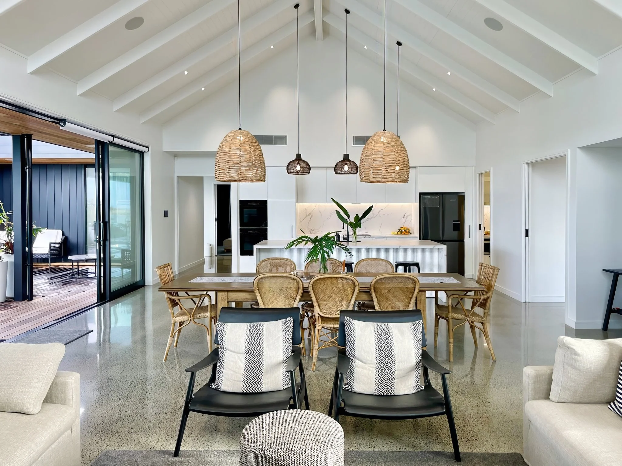 Sand Dune open plan dining and kitchen with rattan pendant lighting, Elite Building Mangawhai