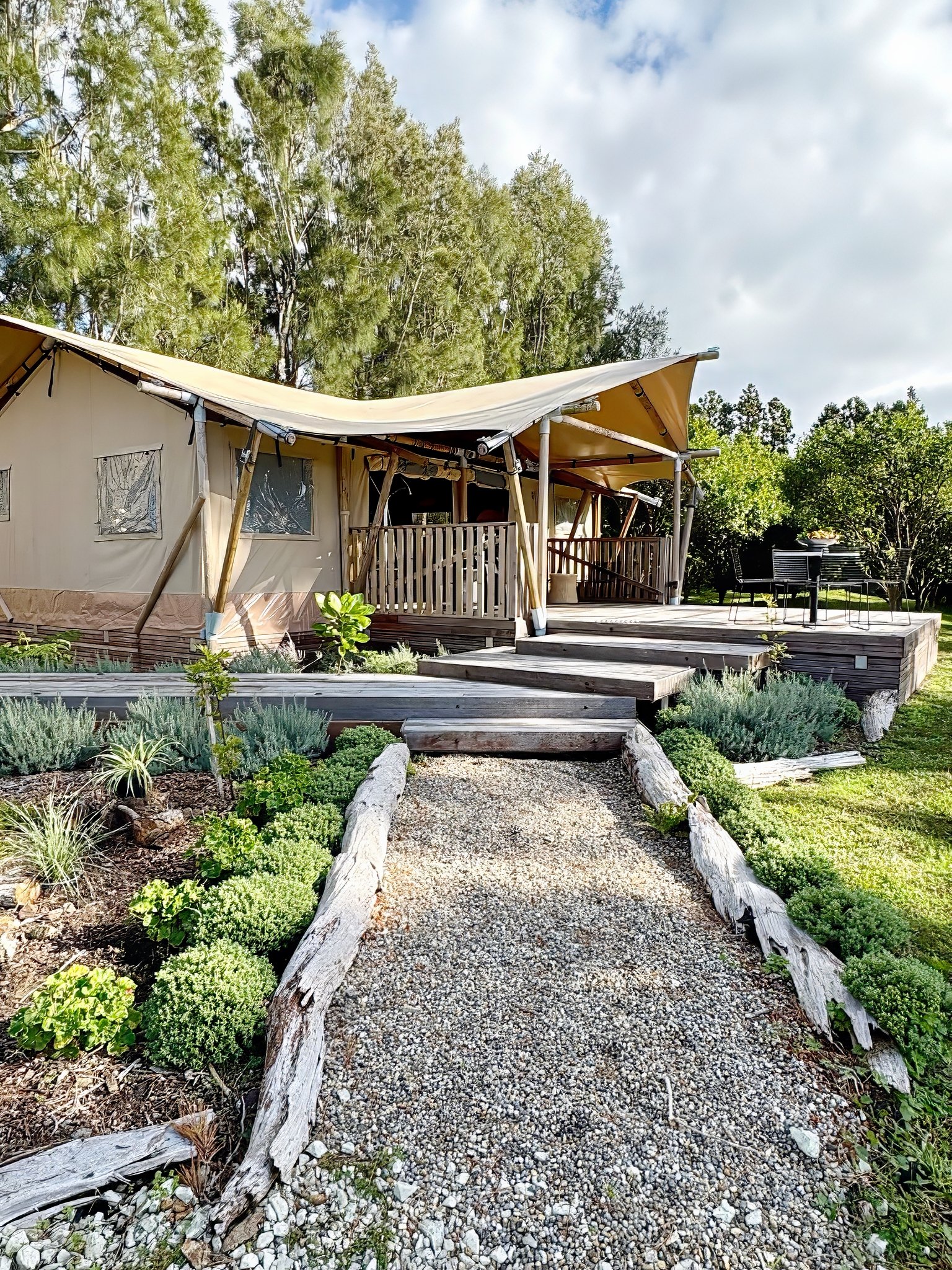 Bespoke glamping retreat exterior with floating timber stairs, Mangawhai