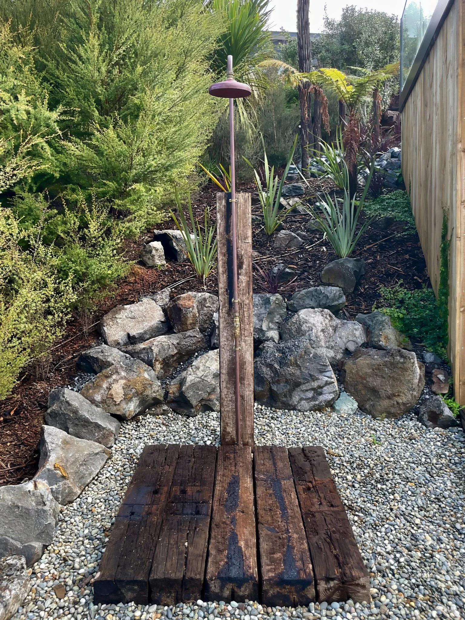 Sand Dune outdoor shower with rock garden feature, Elite Building Mangawhai