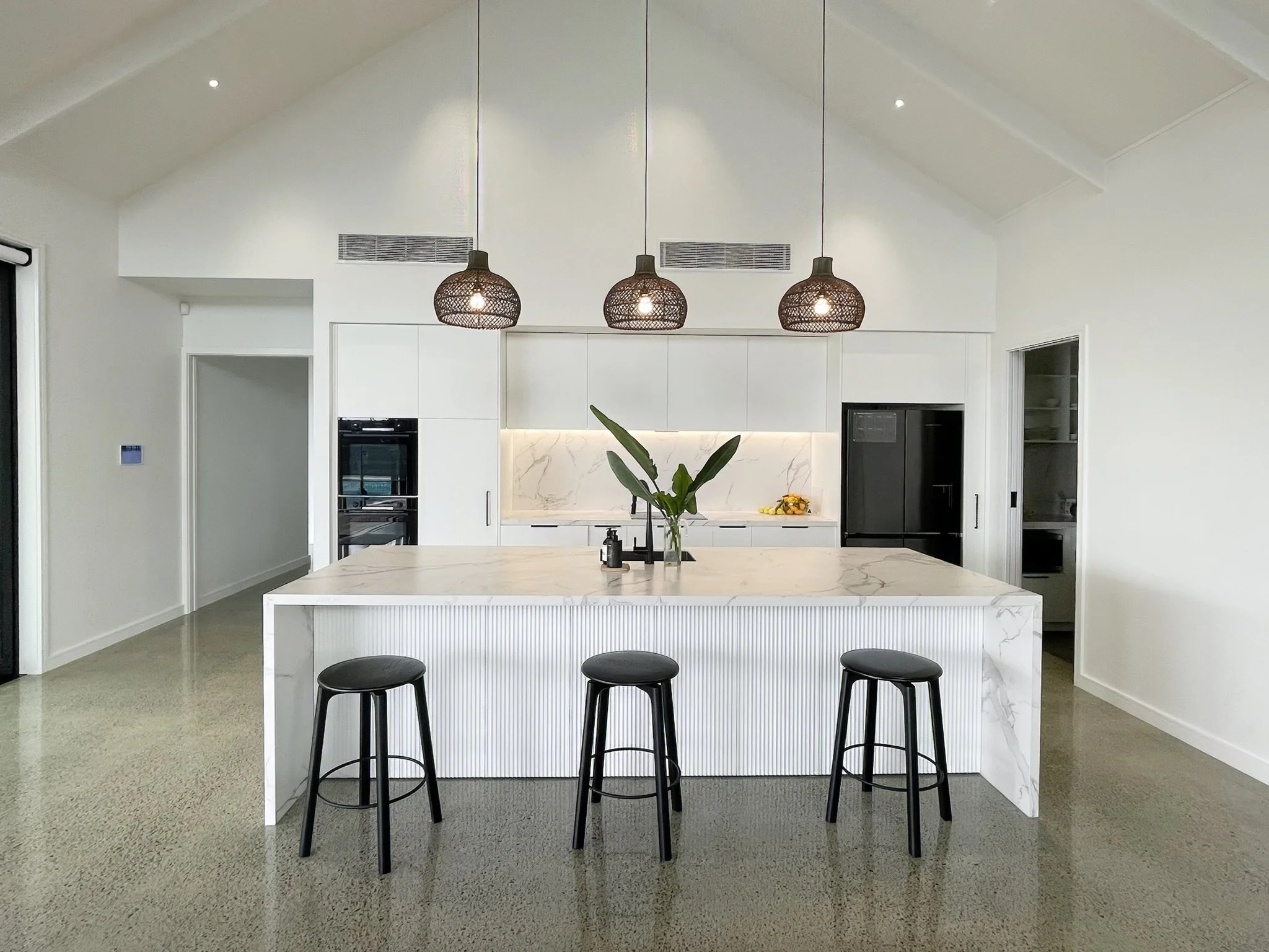Luxury dark kitchen with island bench and pendant lighting, new home build Elite Building Northland