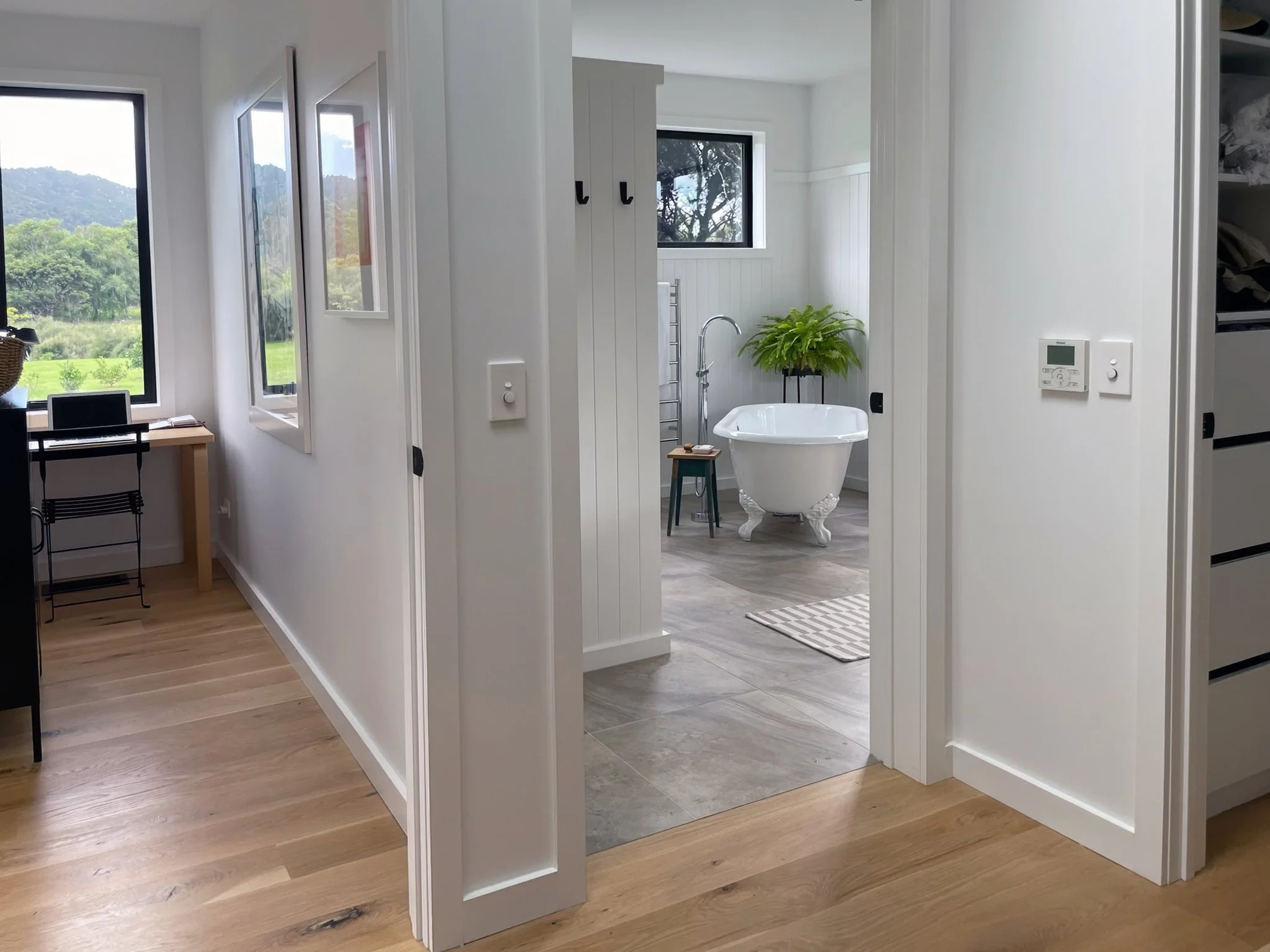 Master ensuite with freestanding bath viewed from bedroom doorway, Waiotahi Drive Elite Building Northland