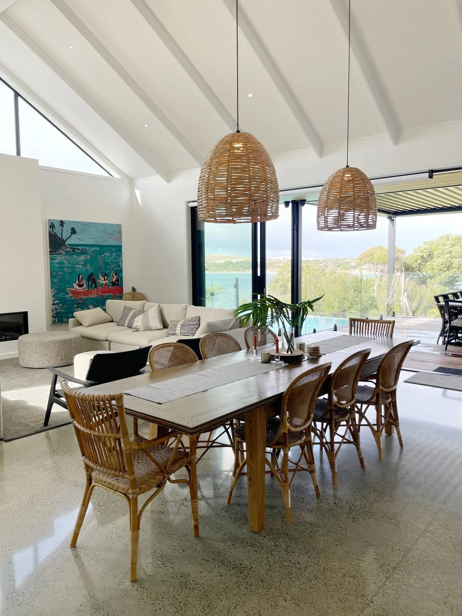 Sand Dune luxury dining room with floor to ceiling windows and Mangawhai Harbour views