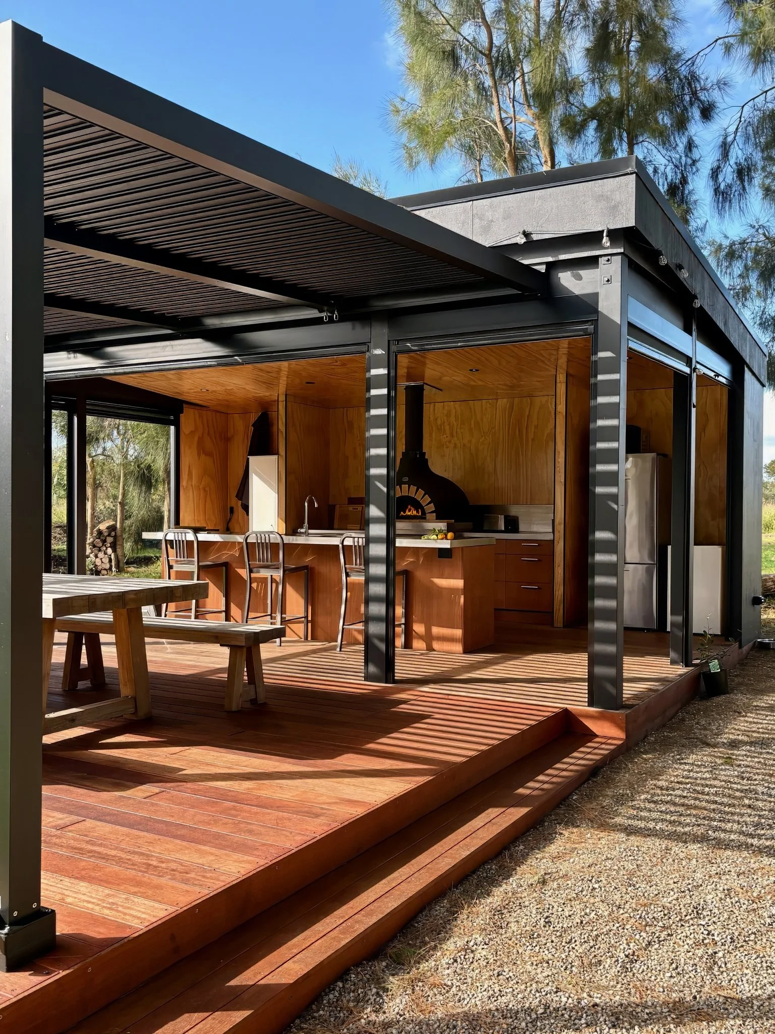 Outdoor dining pavilion with louvre roof, luxury glamping retreat Mangawhai