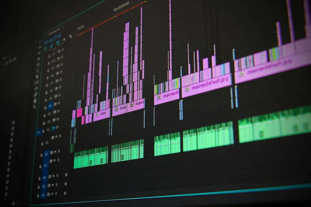 Screenshot of digital audio editing software displaying multicolored audio waveforms and editing tracks.