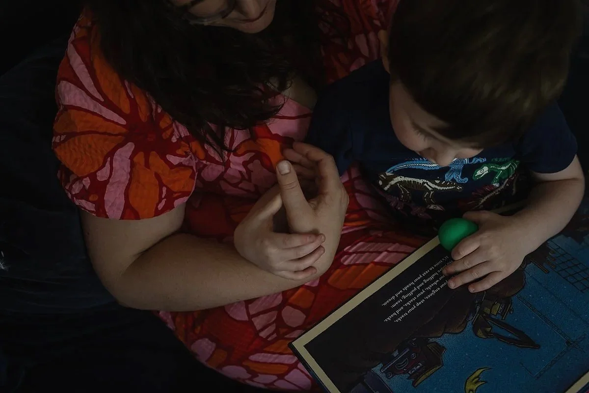 A mother and child holding hands tenderly during a professional family photography session in Cricklewood in North London