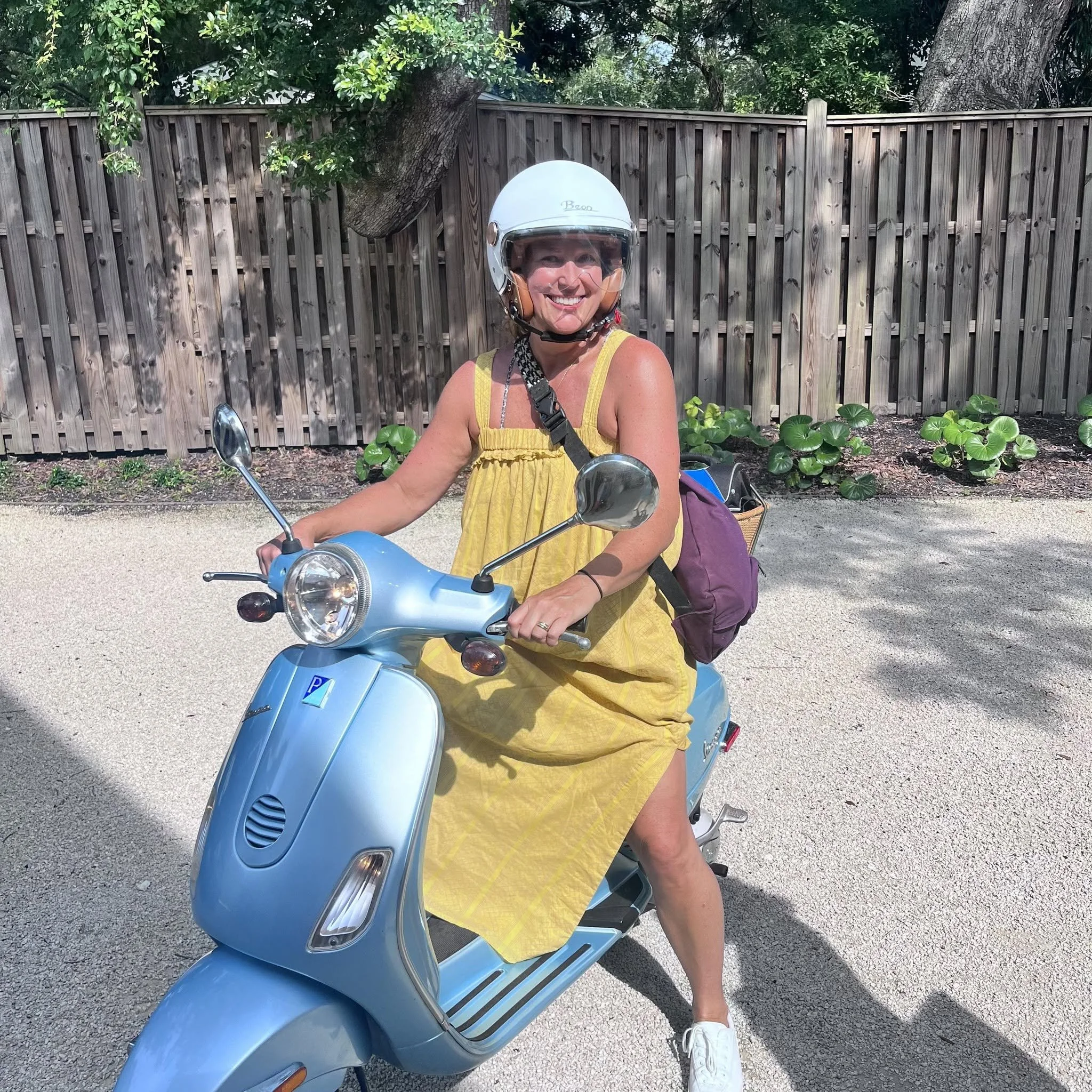 Anne Vardar on a blue vespa running errands