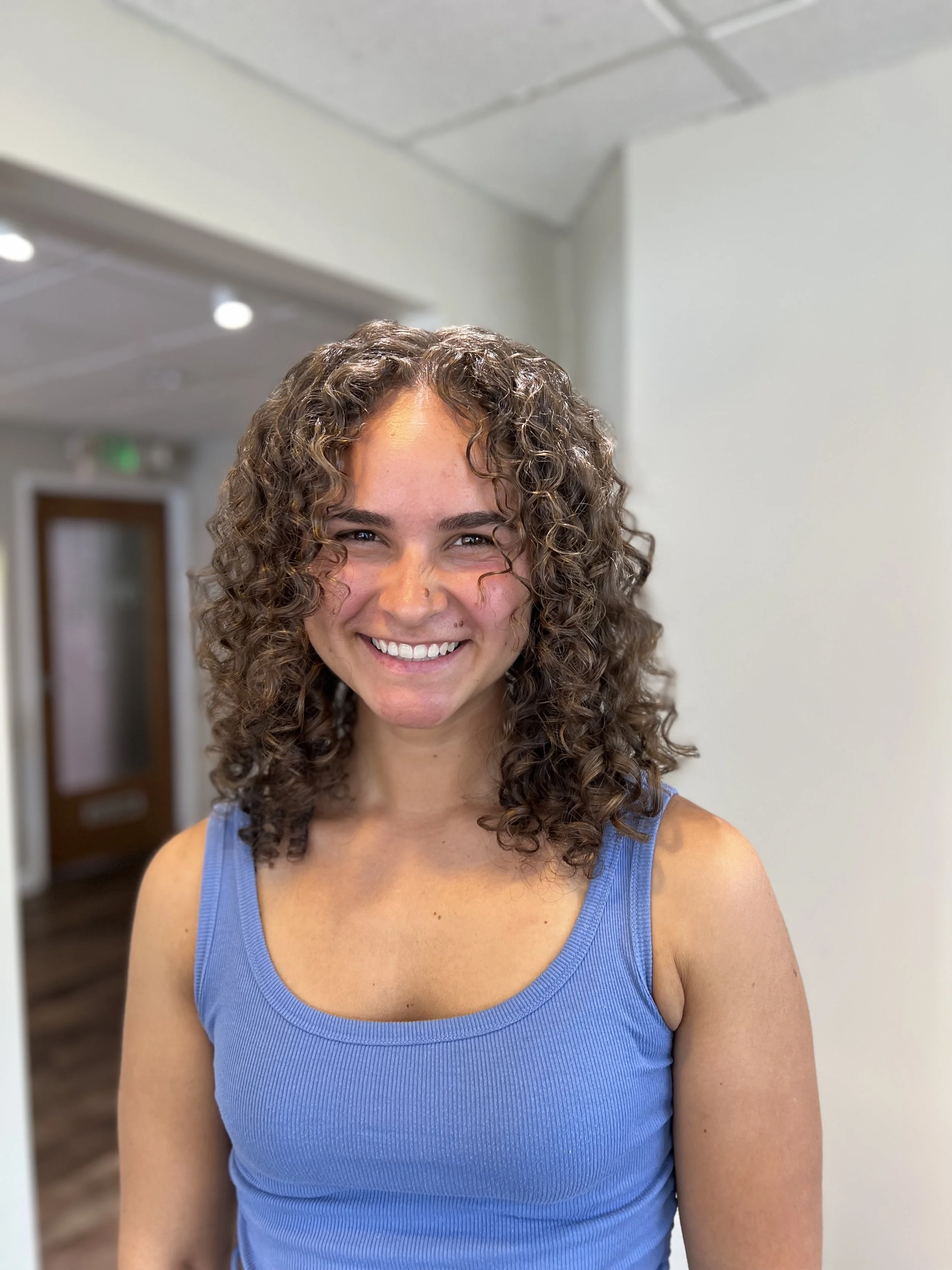 Woman with medium length well-defined curls.