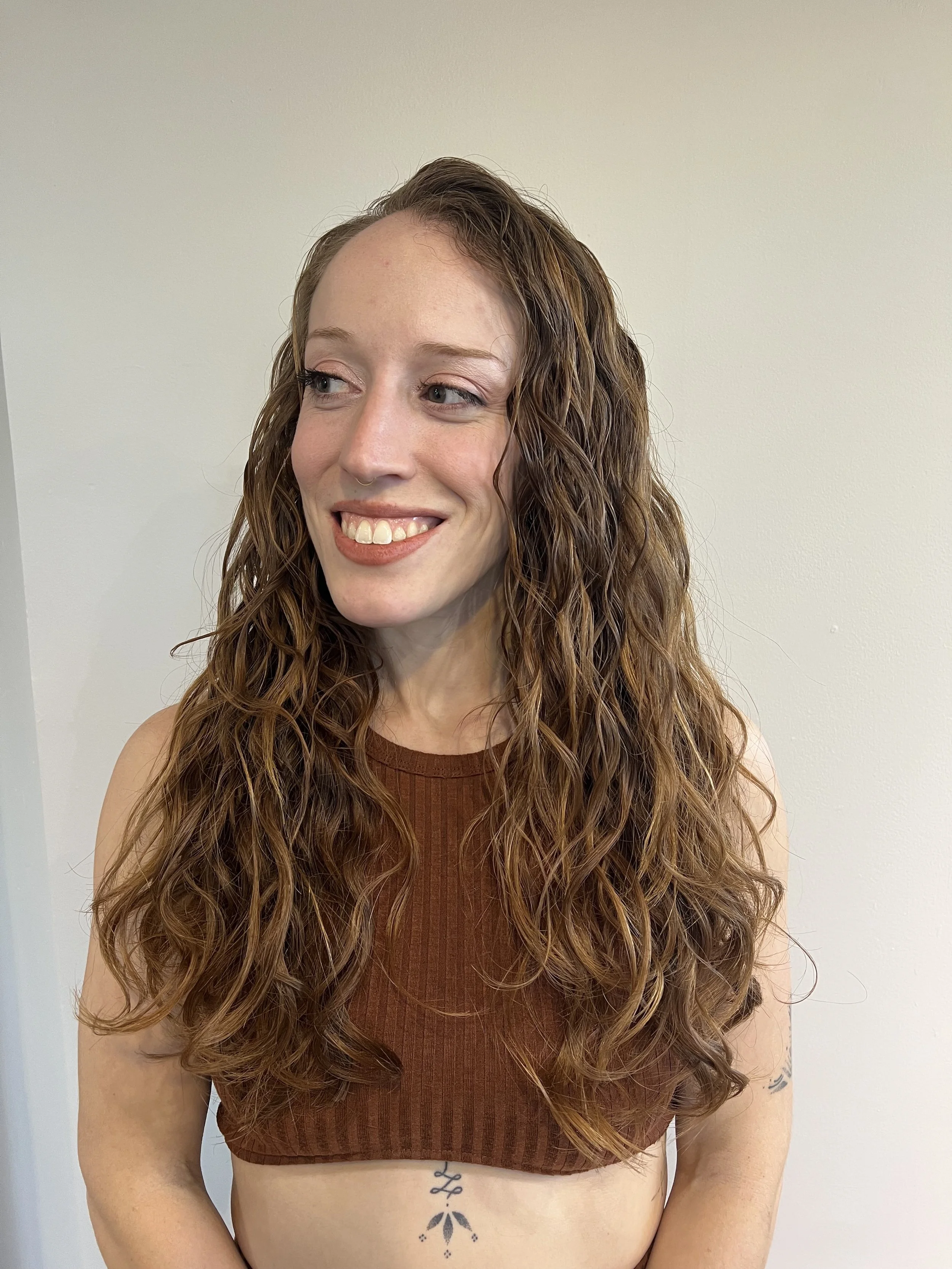 Woman with long, loose 2A waves.