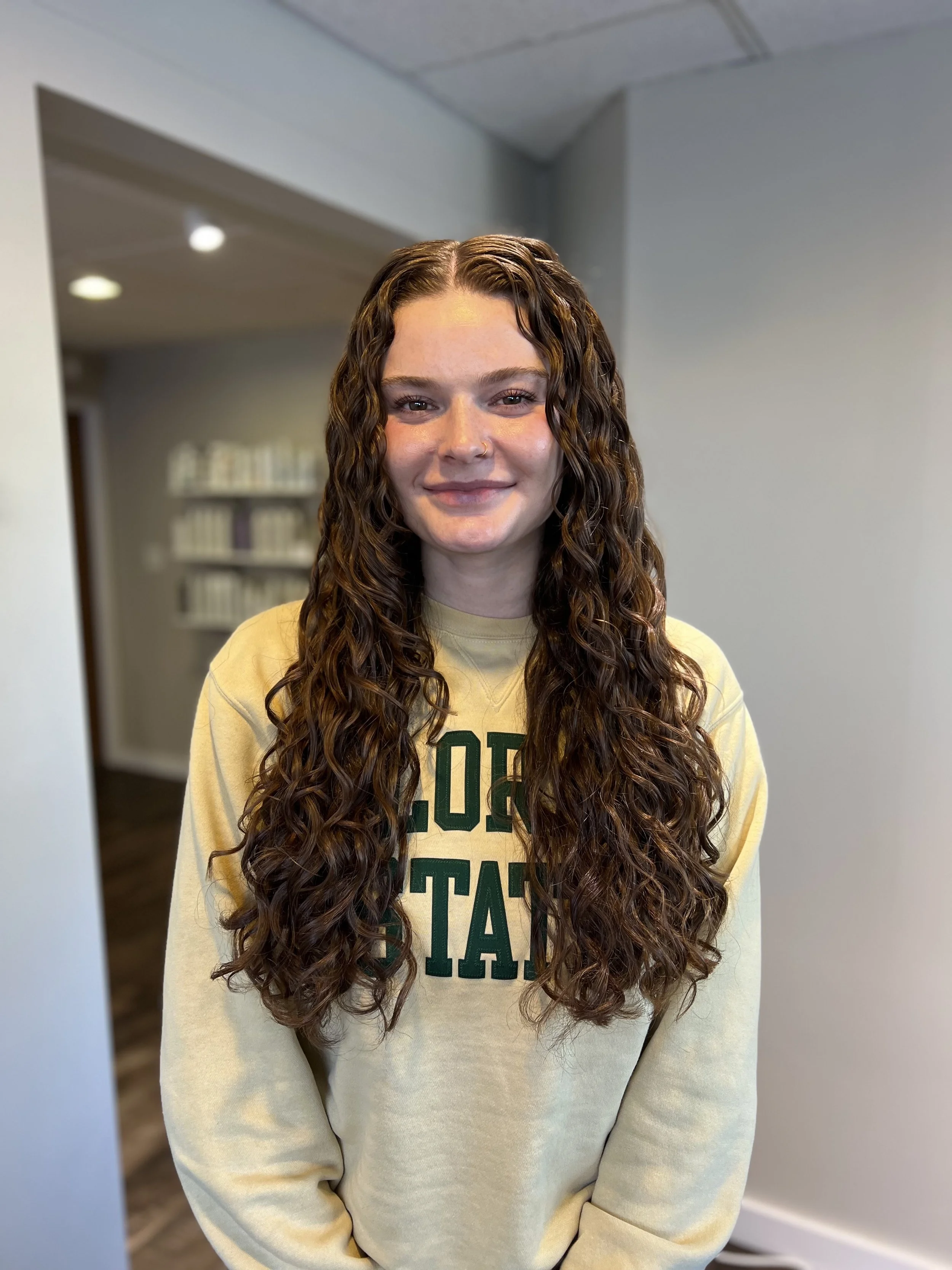 Long wavy curly hair with a deep red color.