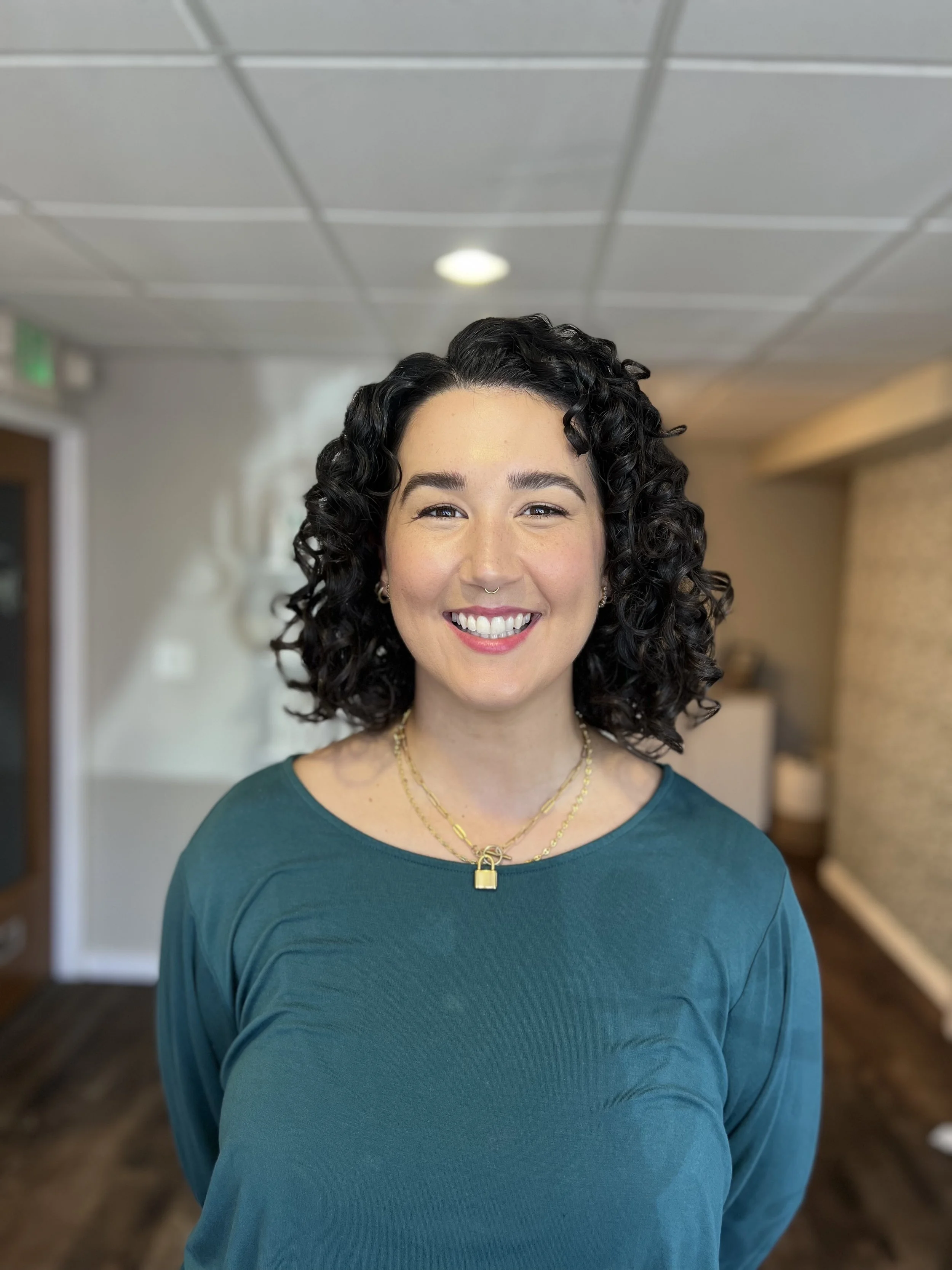 Woman with a curly bob haircut.