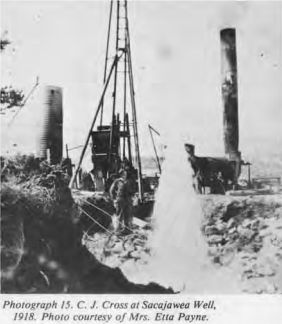 Black and white historical photograph of a fishing boat at Sacajawea Well in 1918, with a steam-powered engine and a dog on the dock.