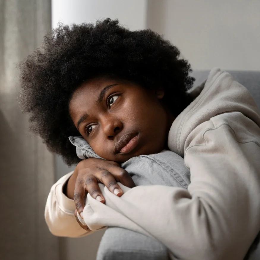 Black woman in therapy for depression in California, processing exhaustion and emotional numbness with a Black therapist