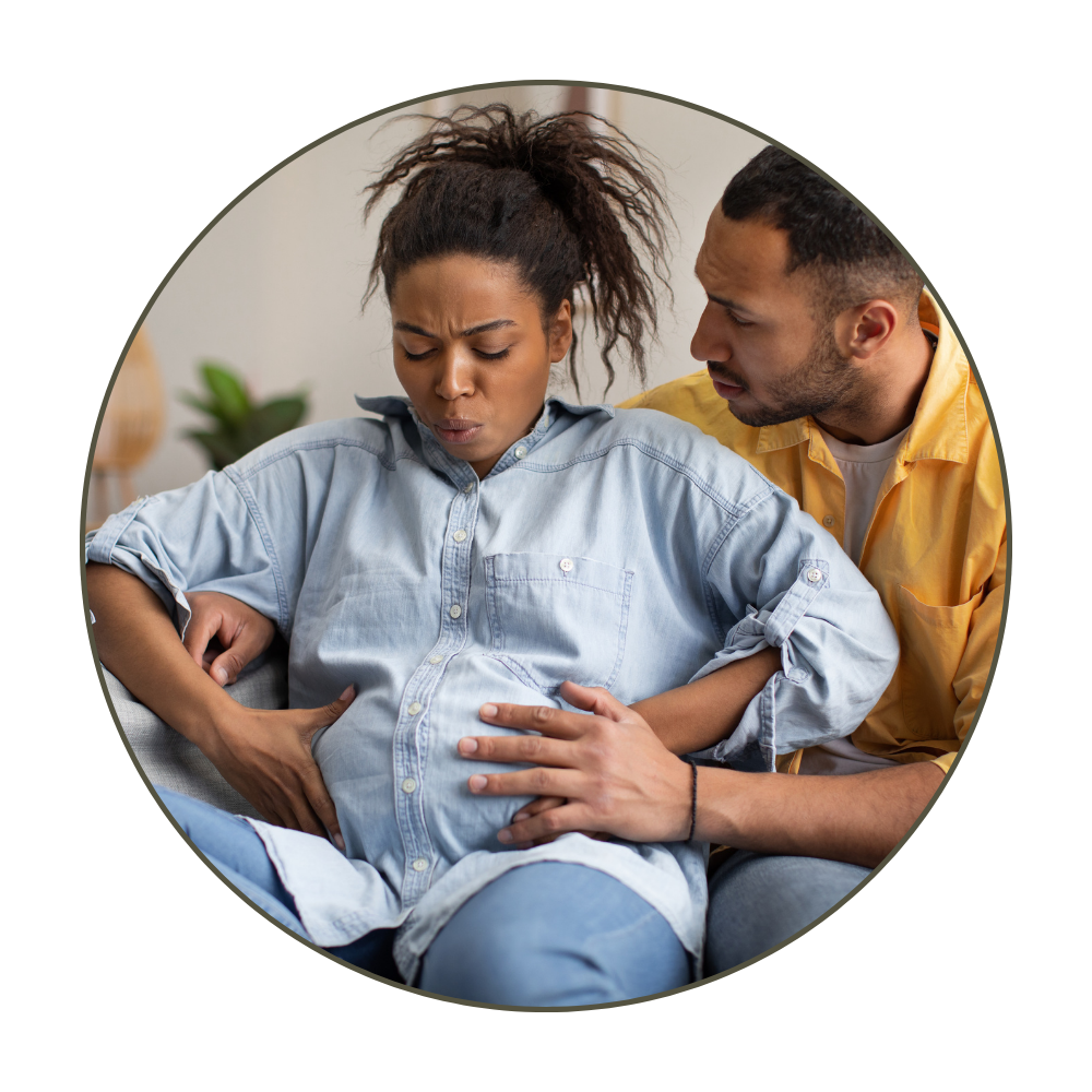 A woman experiencing abdominal pain with a concerned man supporting her