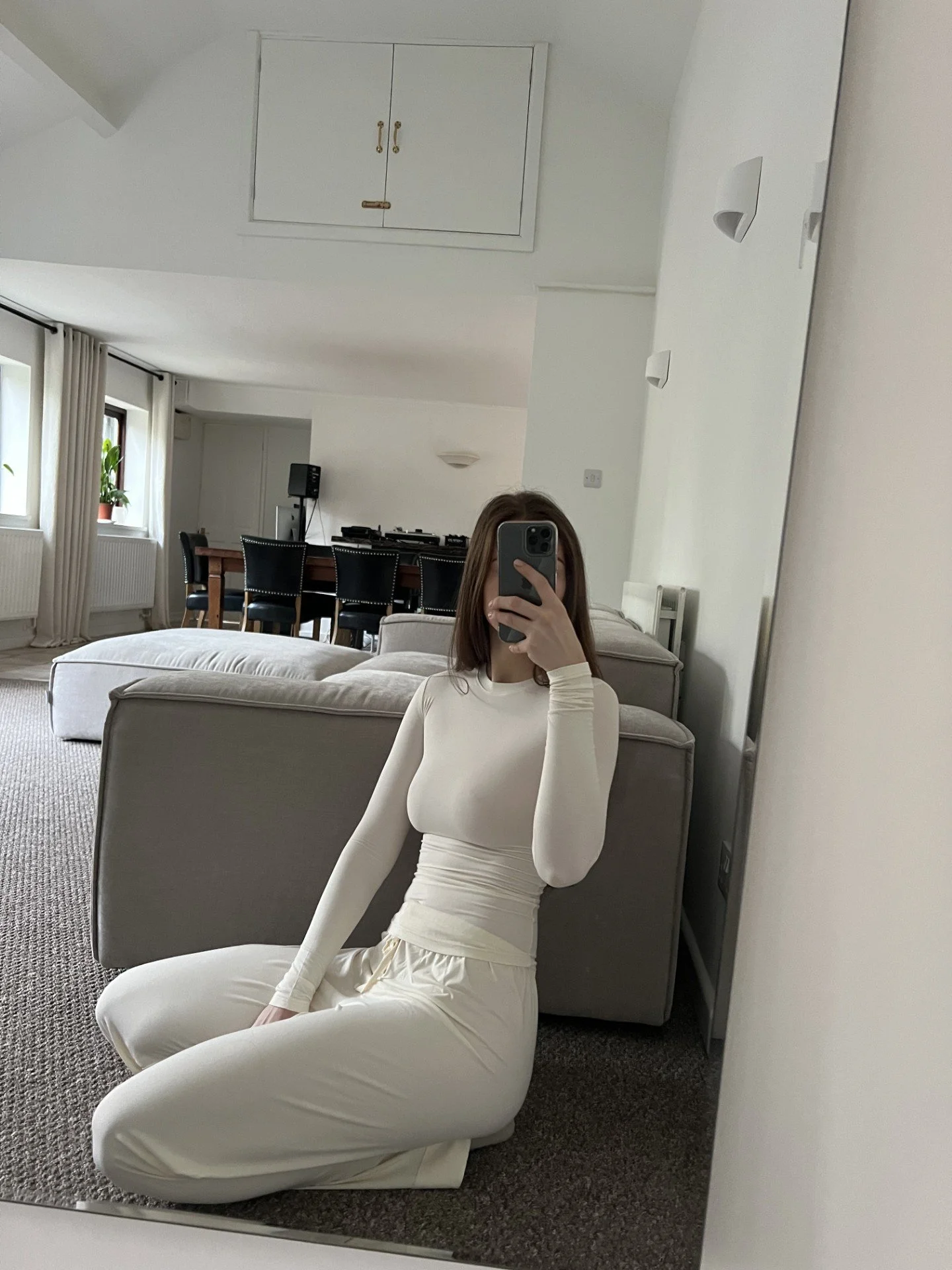 OOTD mirror selfie wearing chic UK minimalistic luxury loungewear womens cream soft bamboo pyjamas in trending cream colour. 