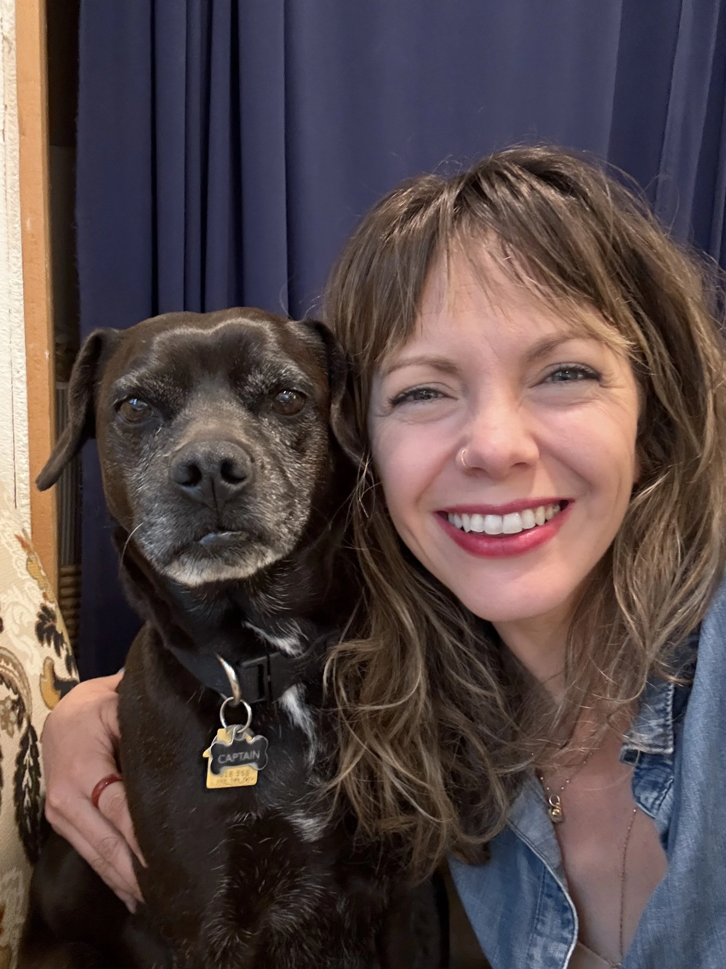 woman poses with dog to illustrate the positive effects of trauma therapy for women