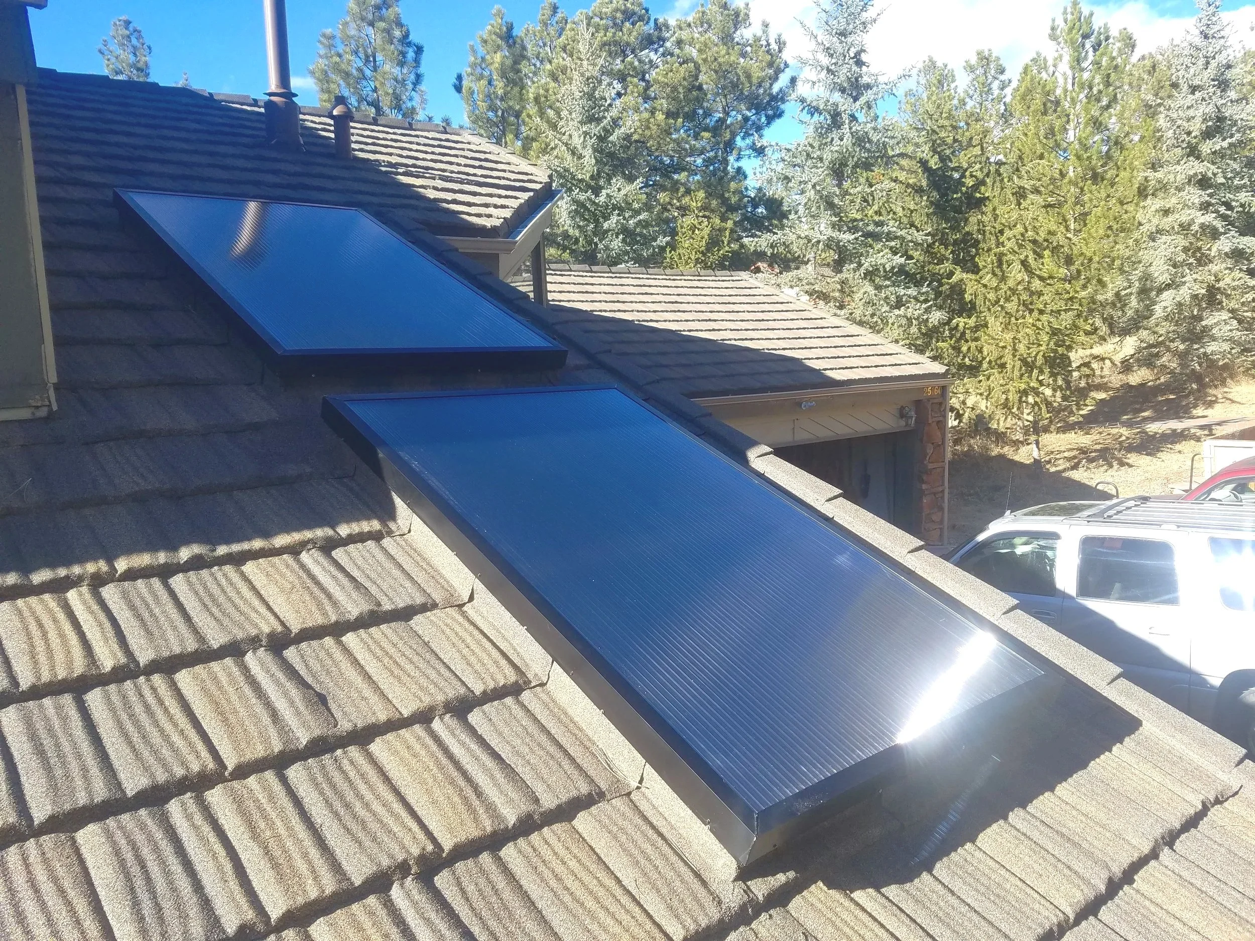 Two structured polycarbonate panel skylights installed on a Stone Coated Steel roof.