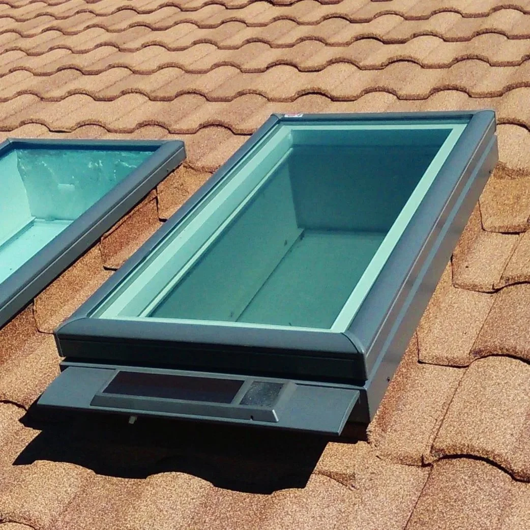 A Velux Solar Powered Curb-Mounted Skylight installed on a Stone Coated Steel Roof.