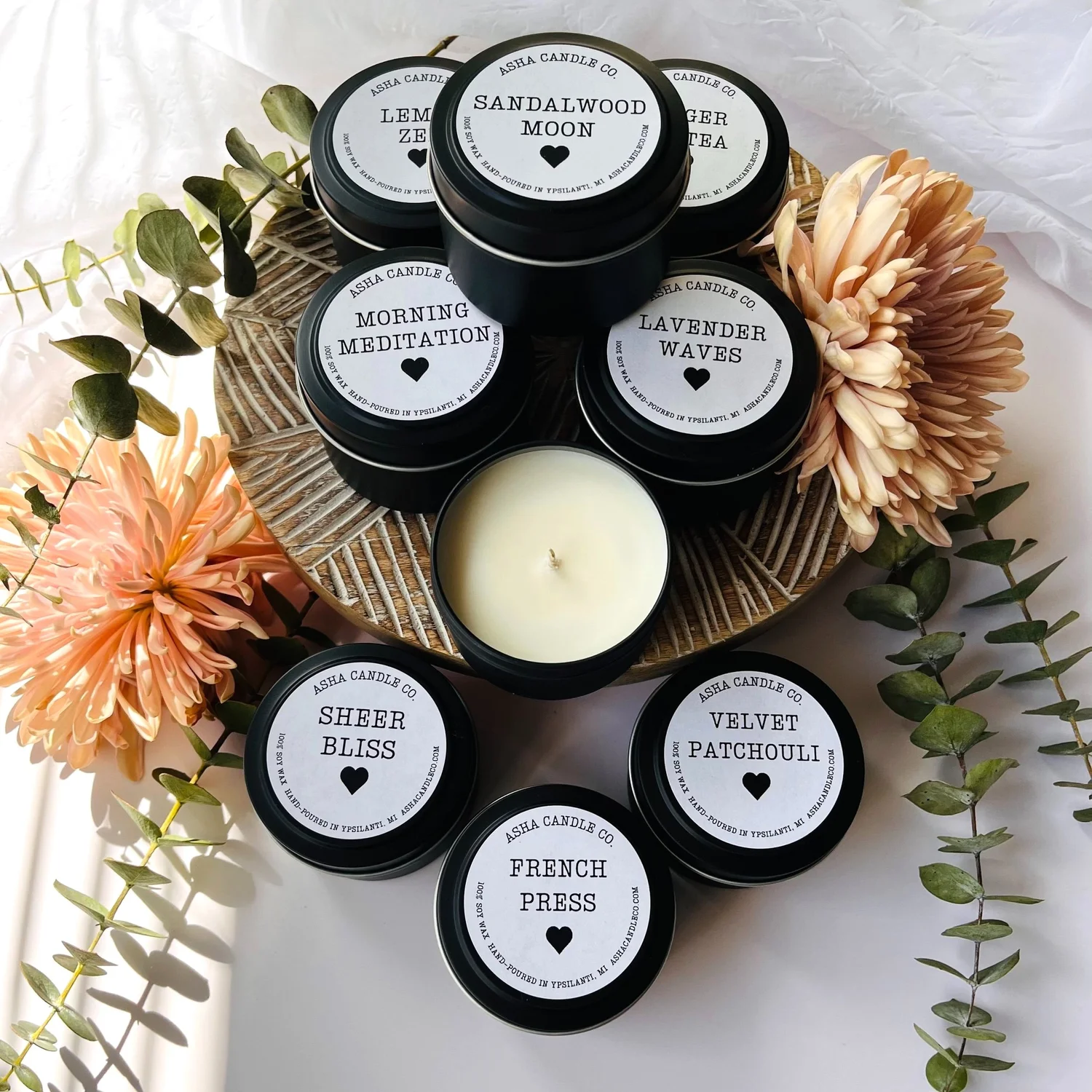 Stack of mixed scented 4oz soy candle in black tins Asha Candle Co.