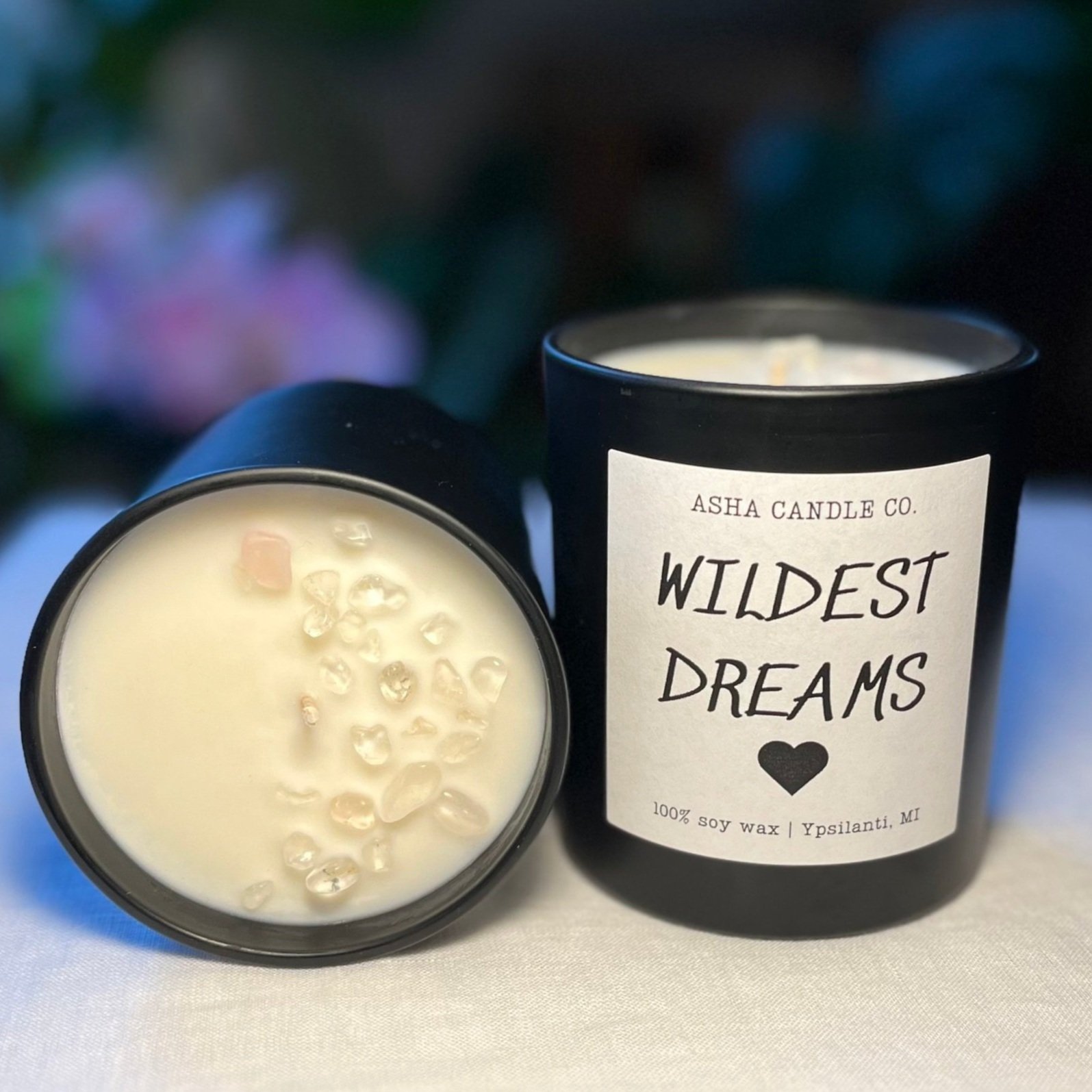wildest dreams candle turned on its side to show the quartz crystals in the shape of the waxing moon