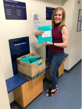 Marcy Bursac mailing donated books and resources at the post office